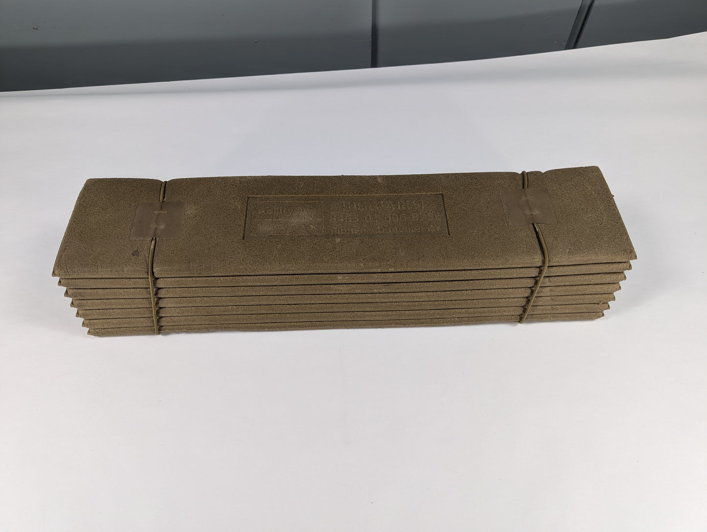 Stack of brown paper bags on a white surface with a gray background
