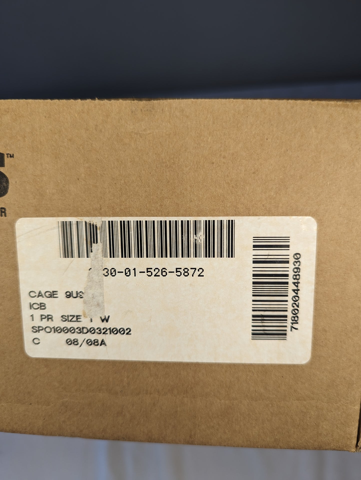 A close-up photograph of the issue label on the Bates Cold Weather Combat Boot box, displaying the size '9UC', the National Stock Number 8430-01-526-5632, and the military contract details.