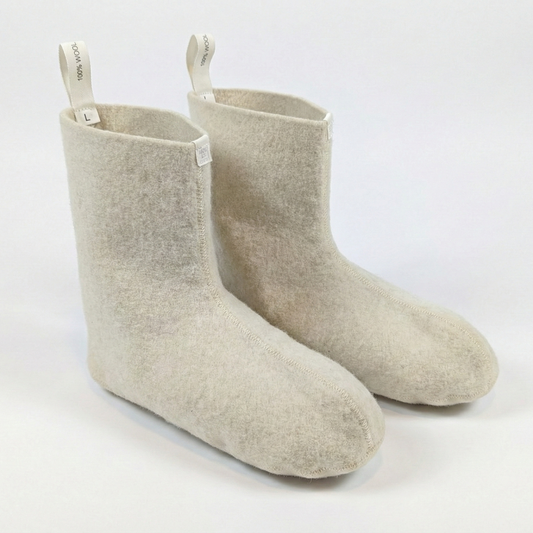 Pair of beige socks with white tags on a white background