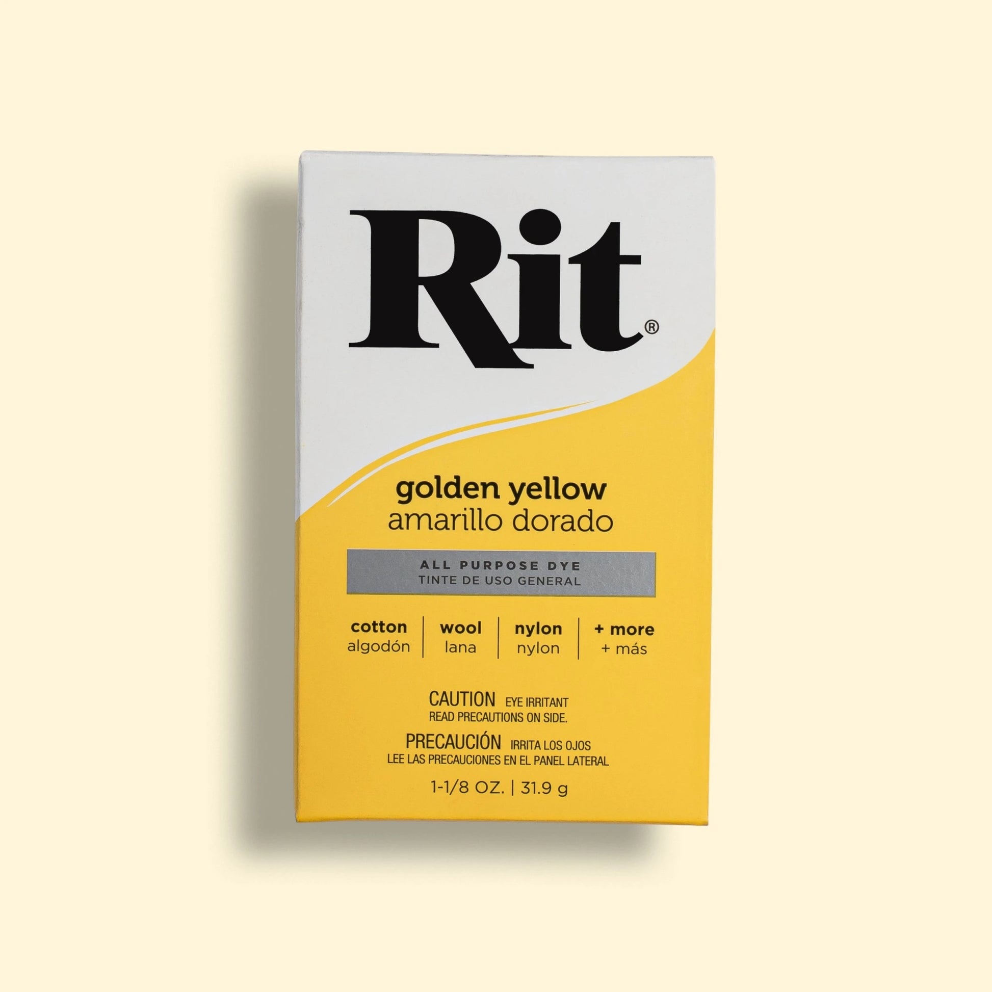 Rit dye packaging in golden yellow on a beige background