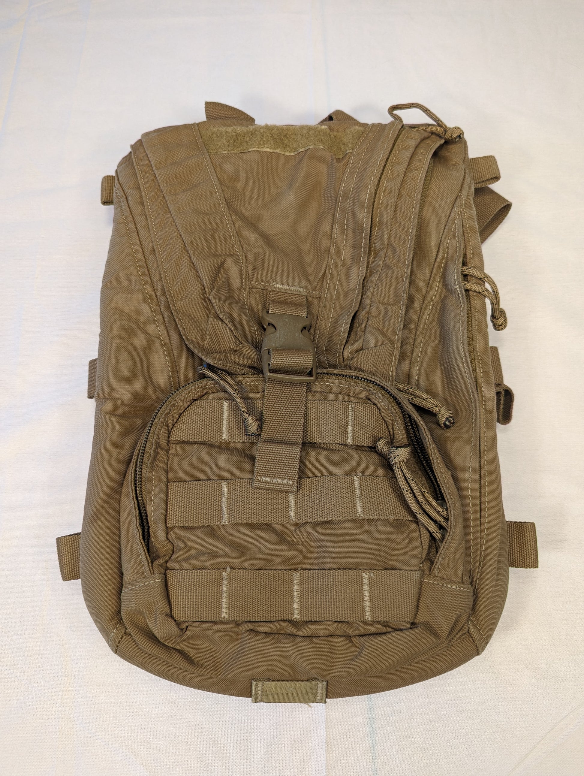 Brown tactical backpack on a white background