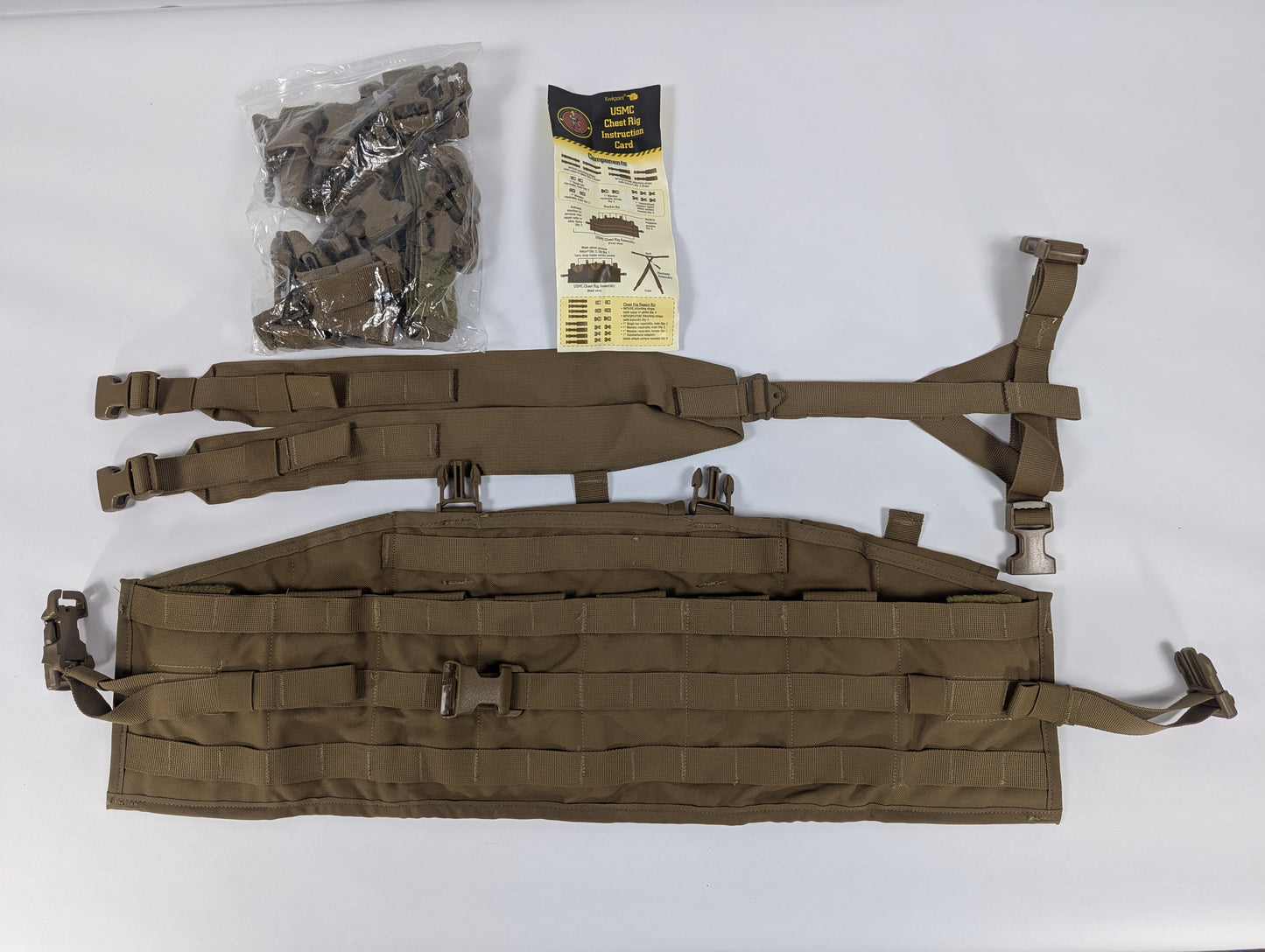 Brown tactical vest with straps and a package on a white background