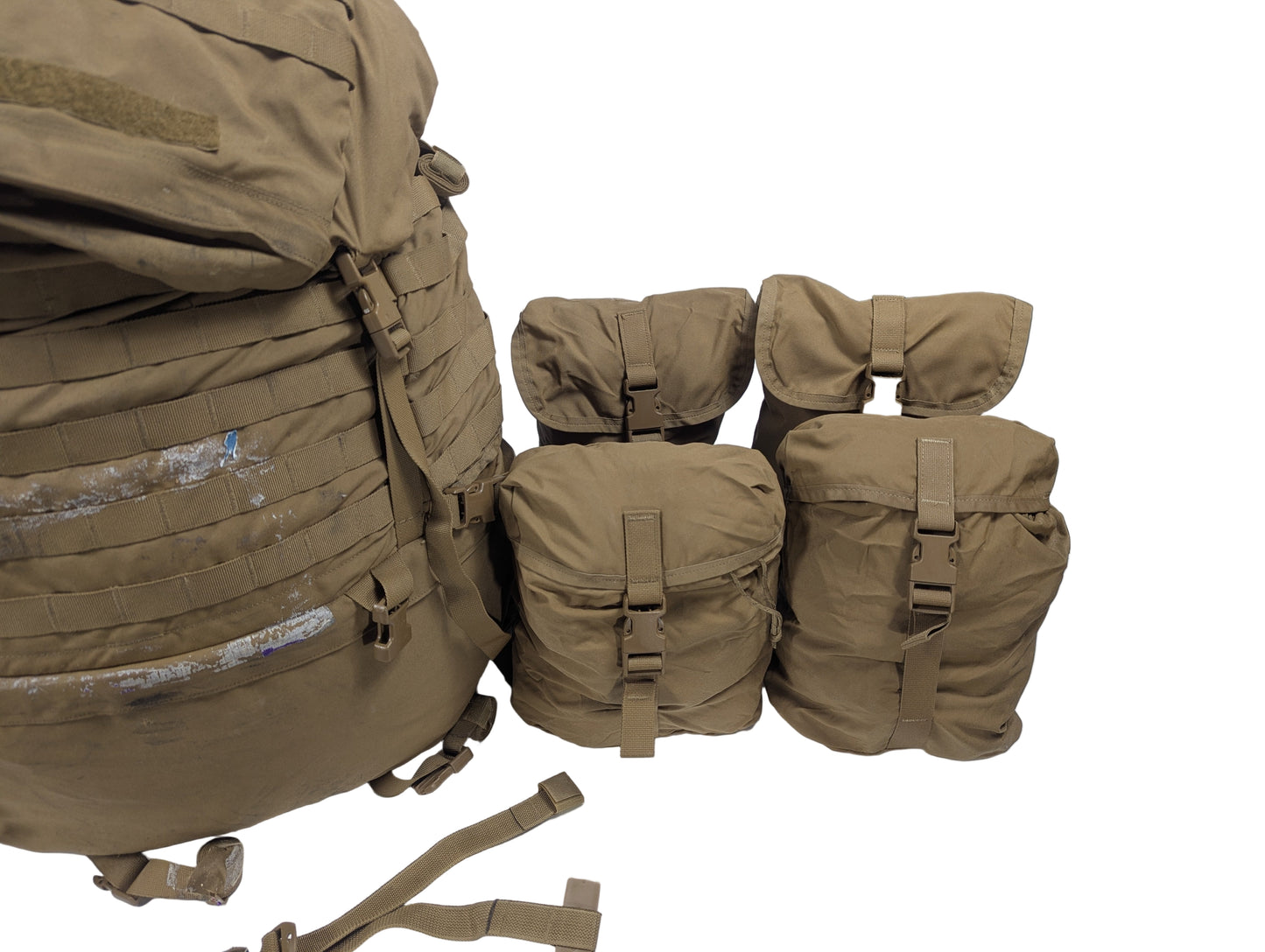 Tan military backpack and pouches on a white table