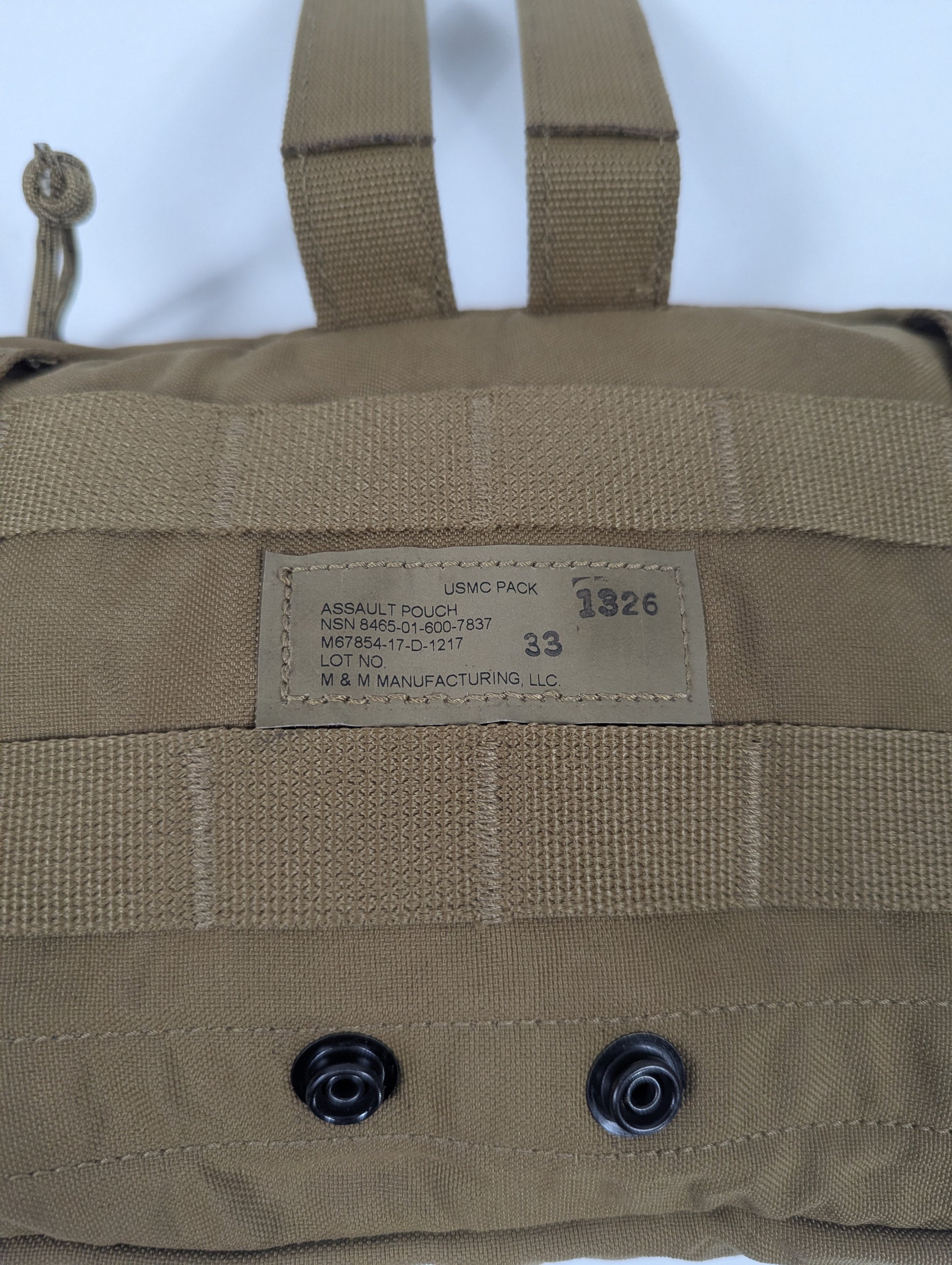 Tan military-style pouch with a label on a white background