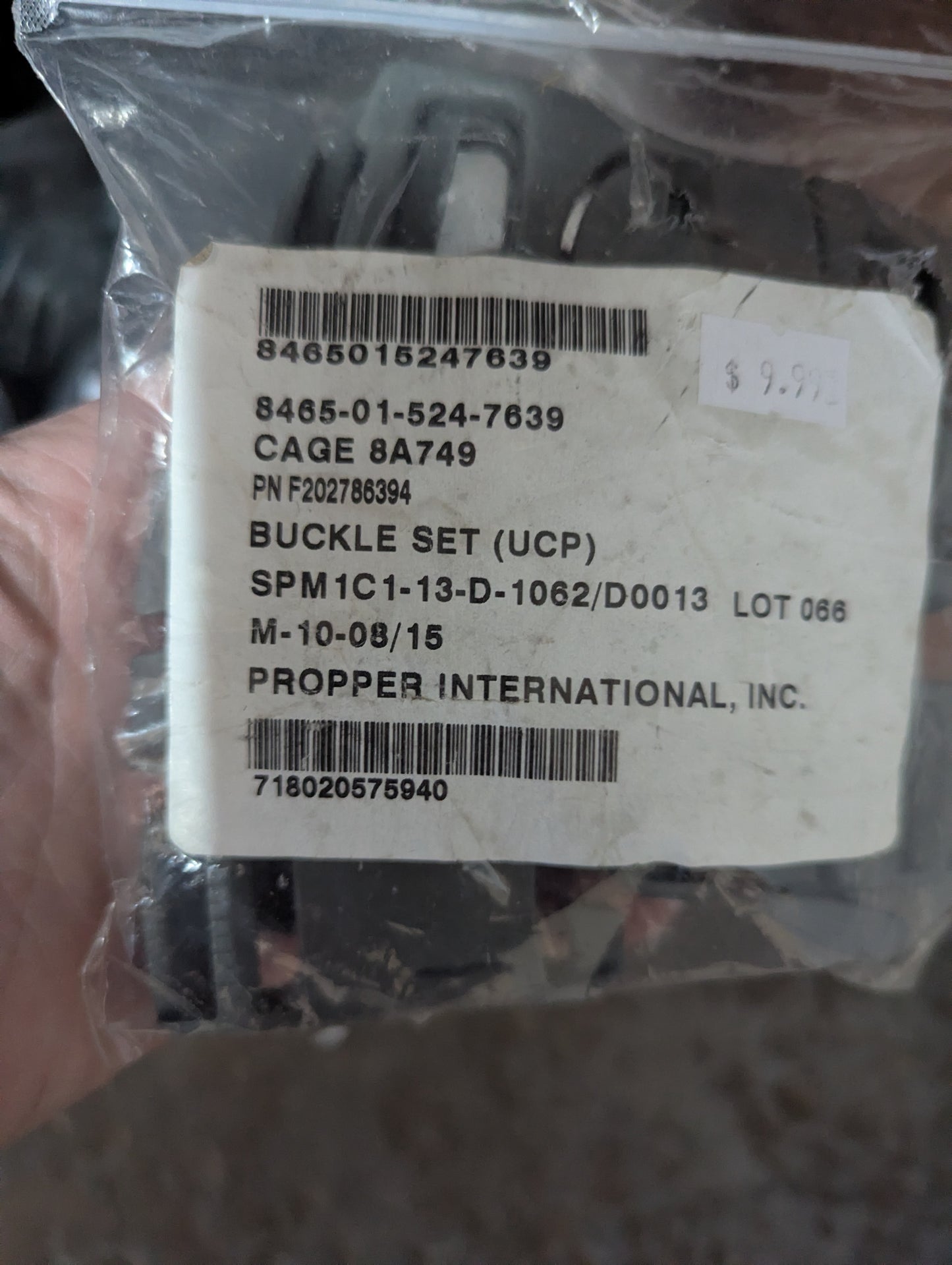 Packaged buckle set with labels and barcodes on a clear background