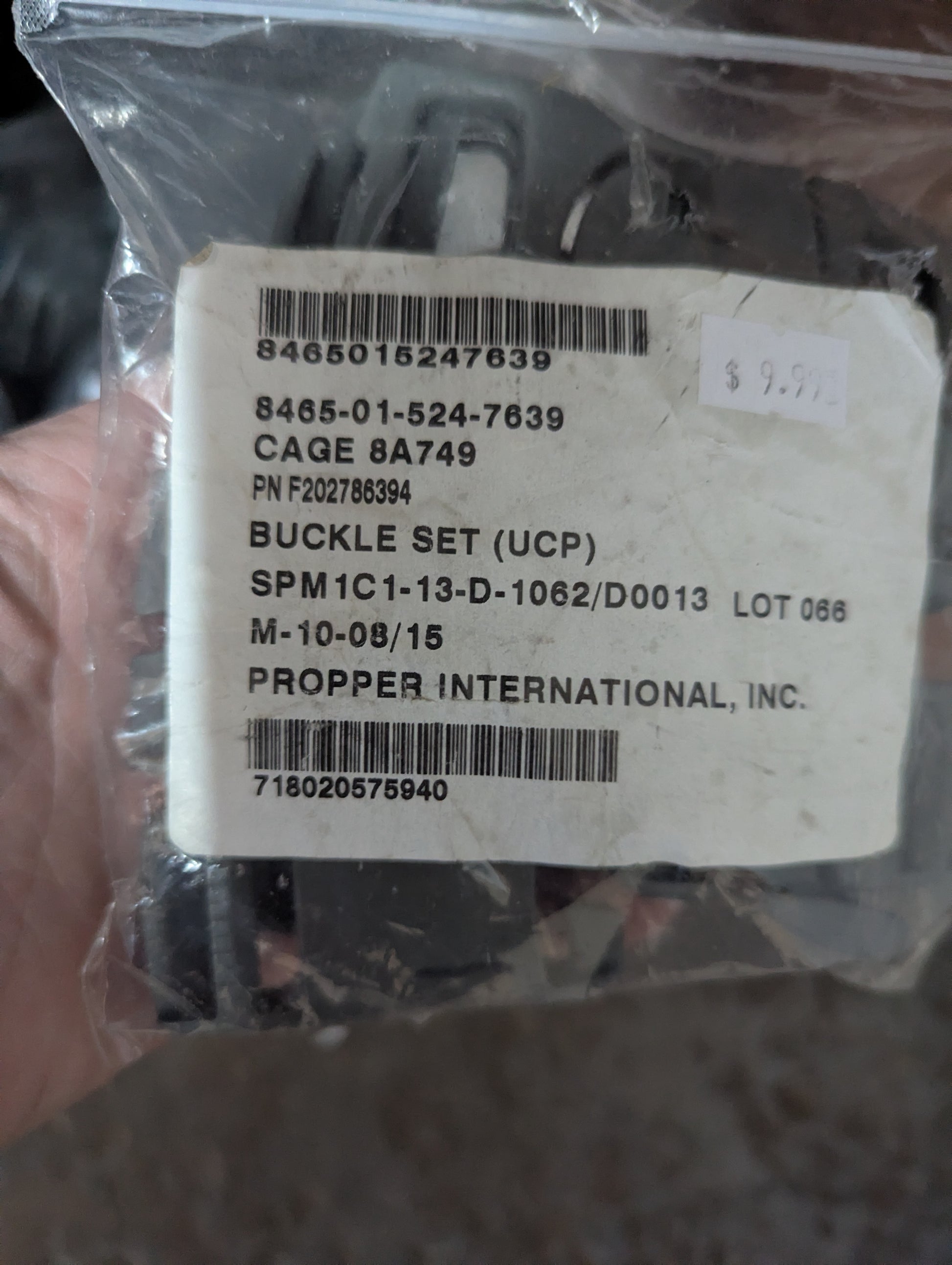 Packaged buckle set with labels and barcodes on a clear background