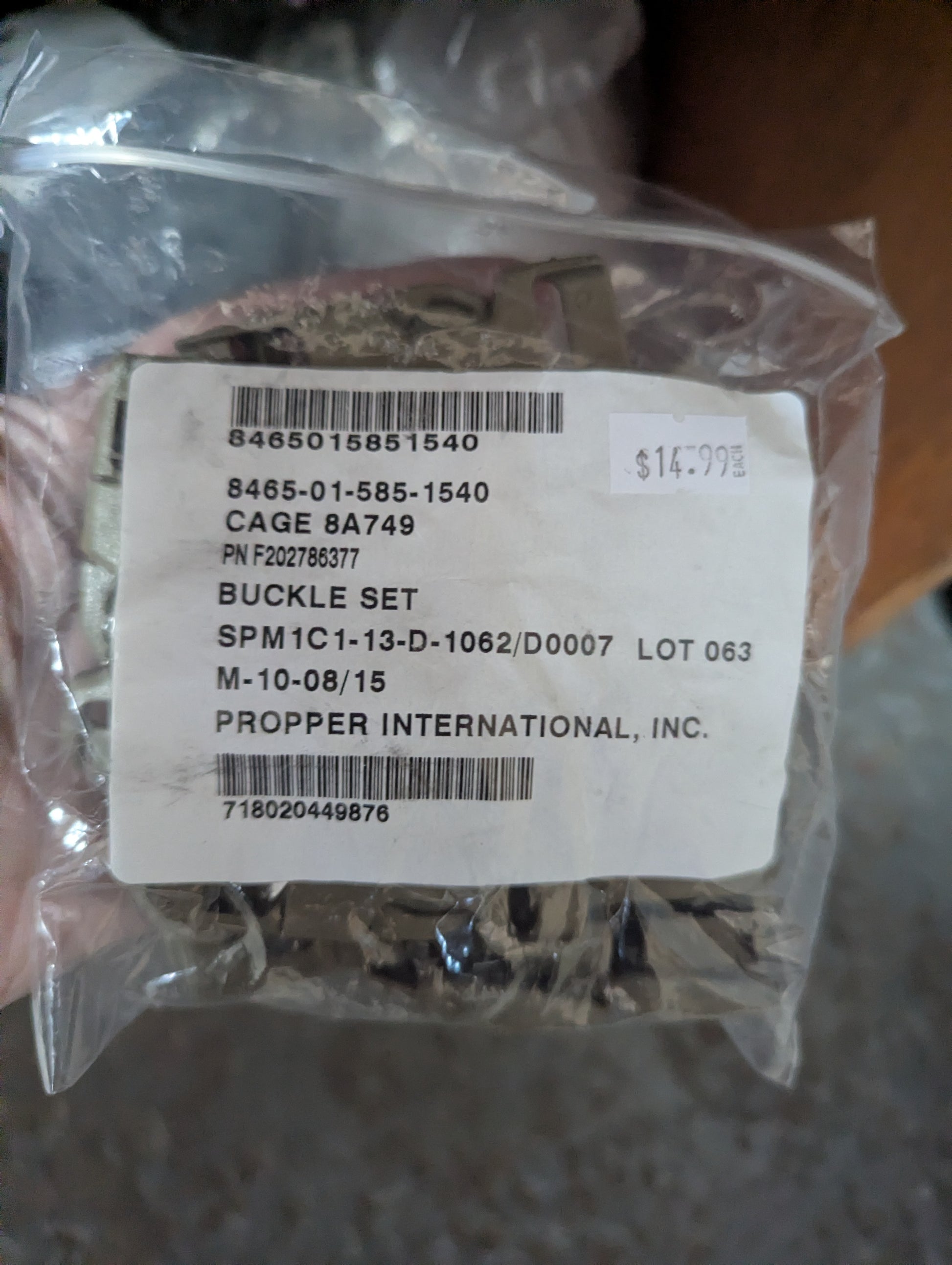 Package of a buckle set with a label on a blurred background