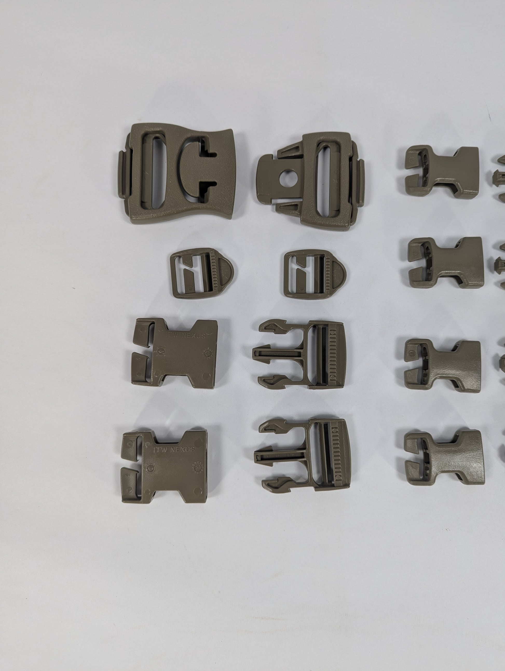Set of metallic clip components on a white background