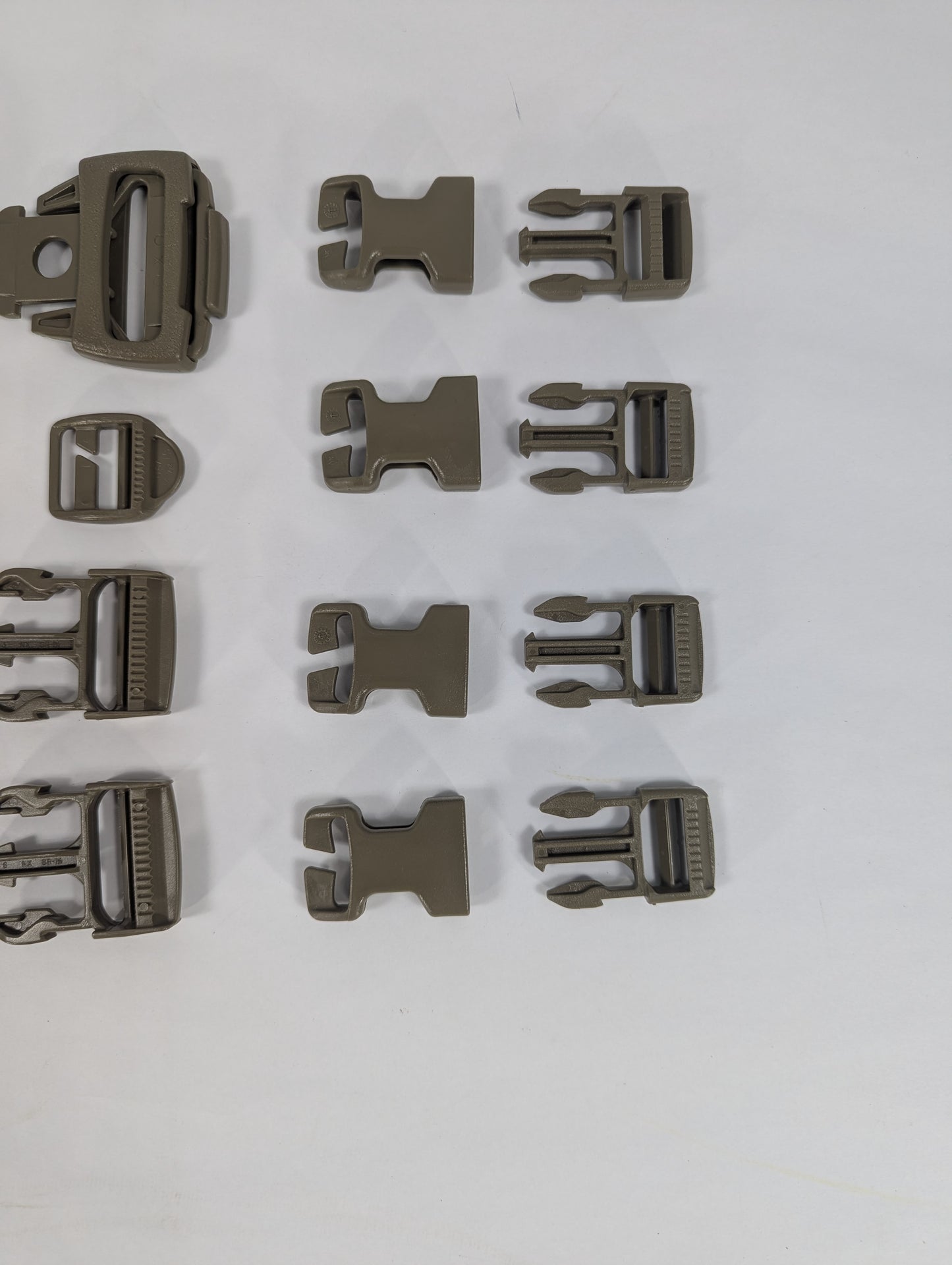 Set of brown buckles arranged in a grid on a white background