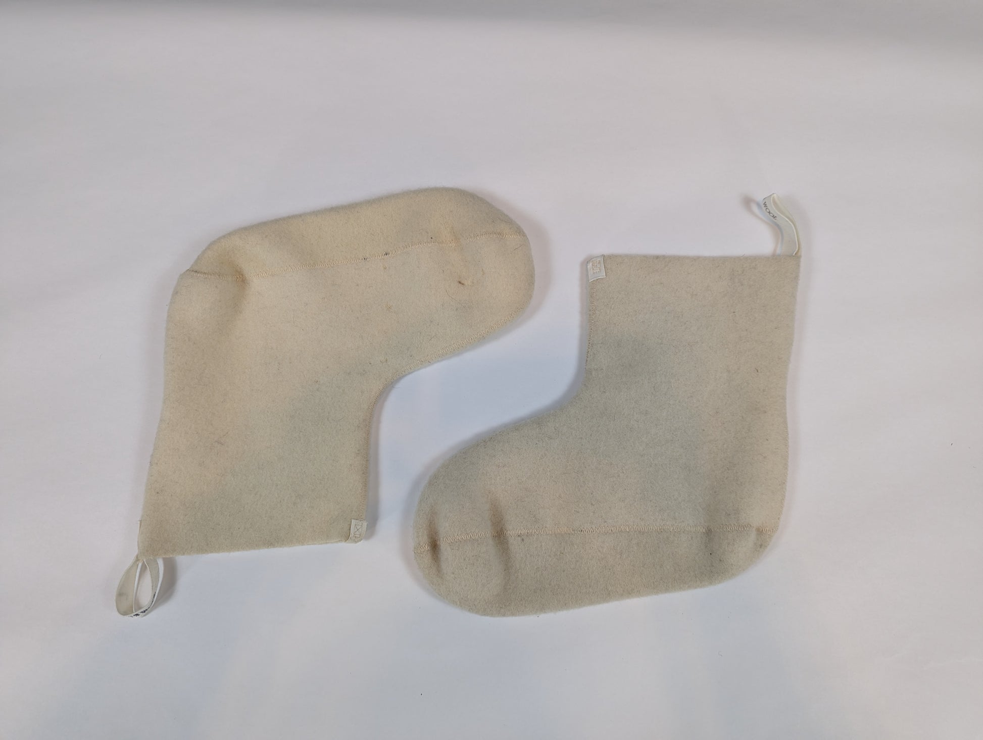 Two beige fabric bags on a white background