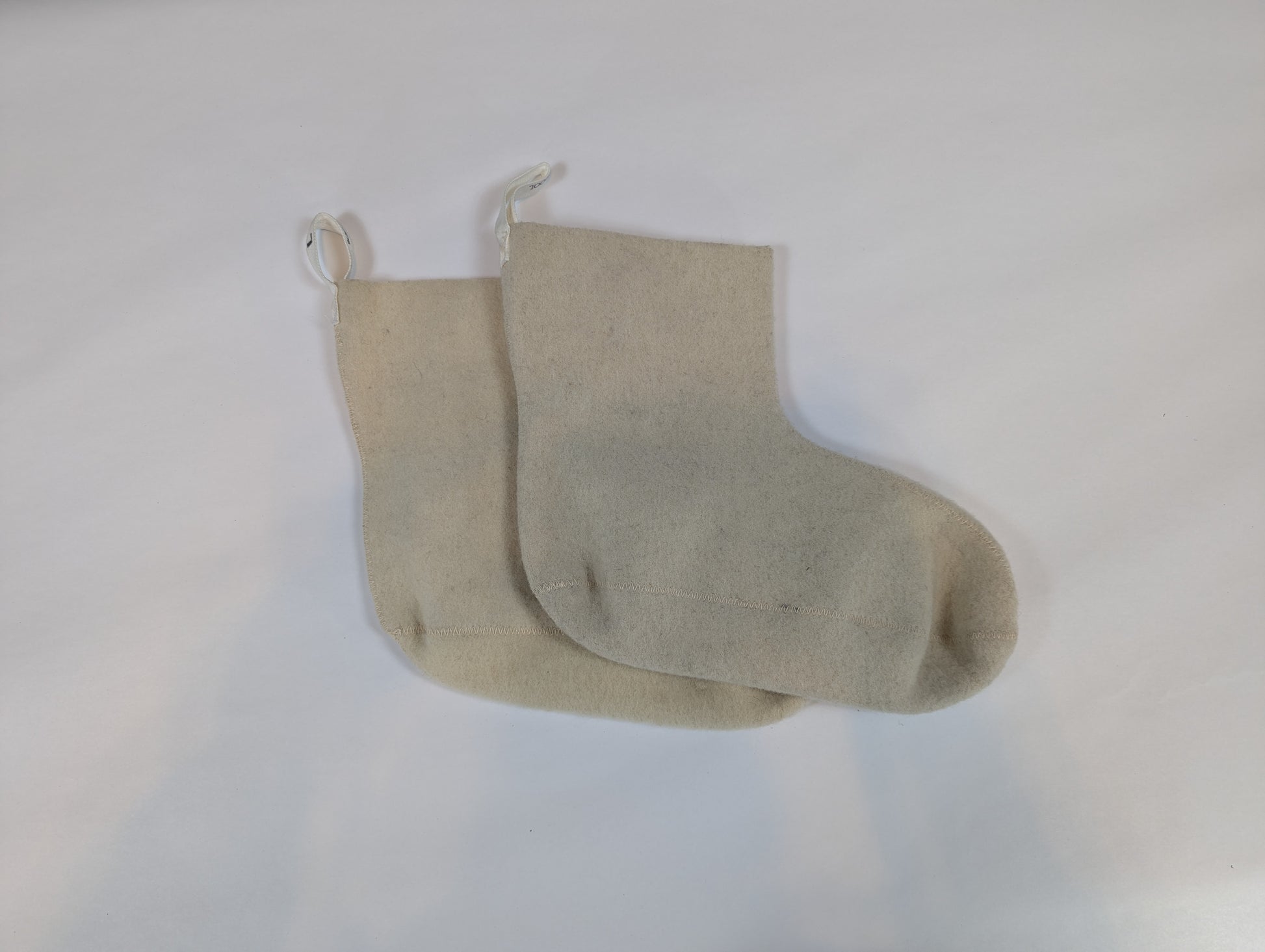 Beige fabric stocking on a white background