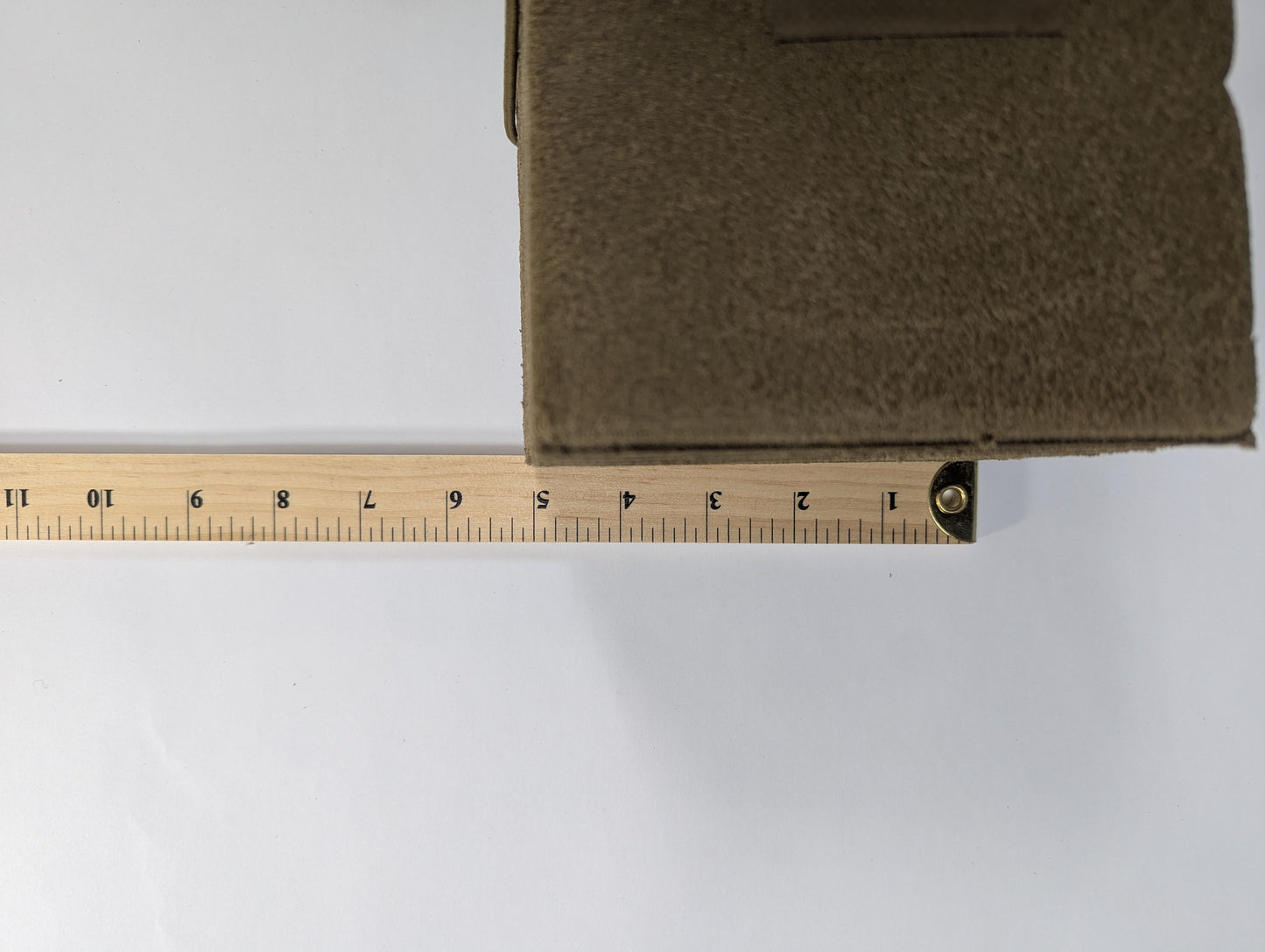 Brown fabric with a wooden measuring ruler on a white background