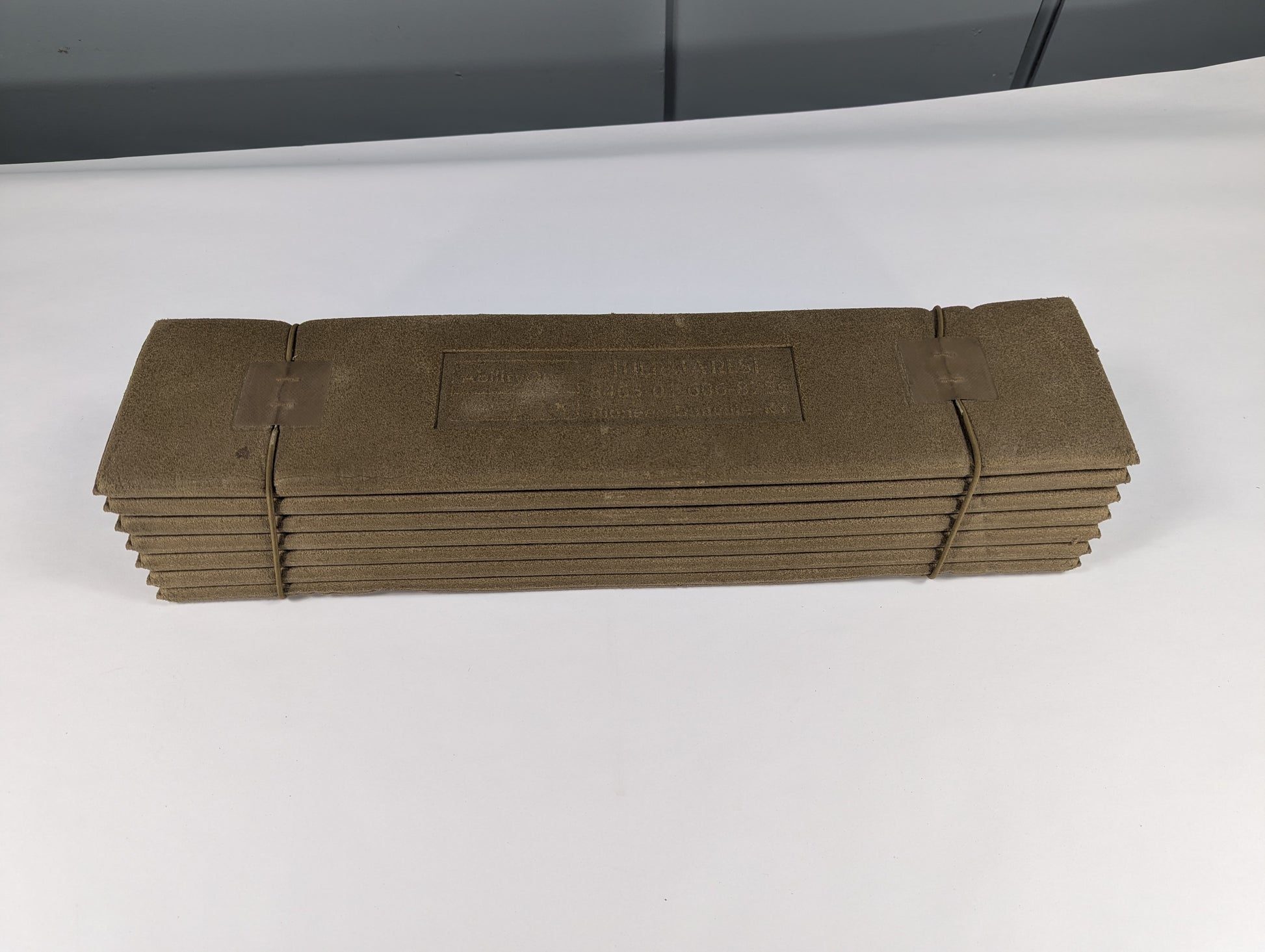 Stack of brown paper bags on a white surface with a gray background