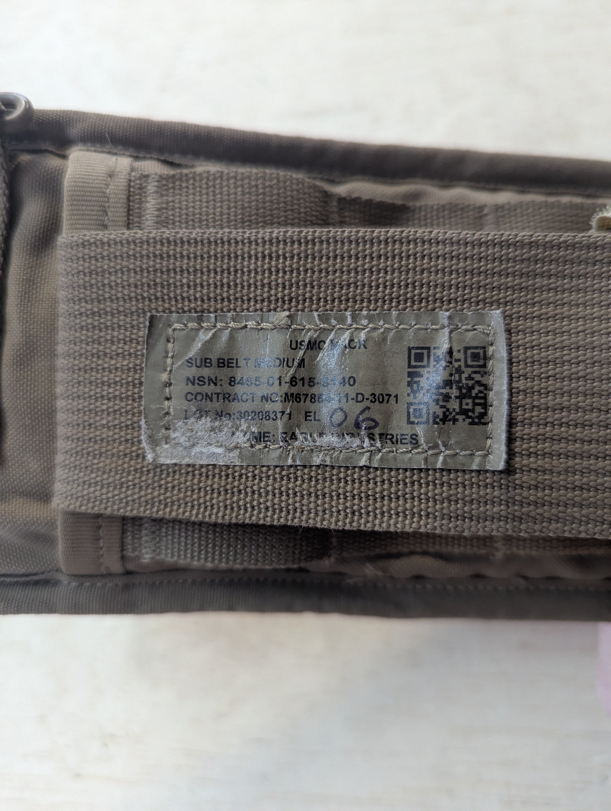 Label on a military-style pouch with text and QR code on a white background