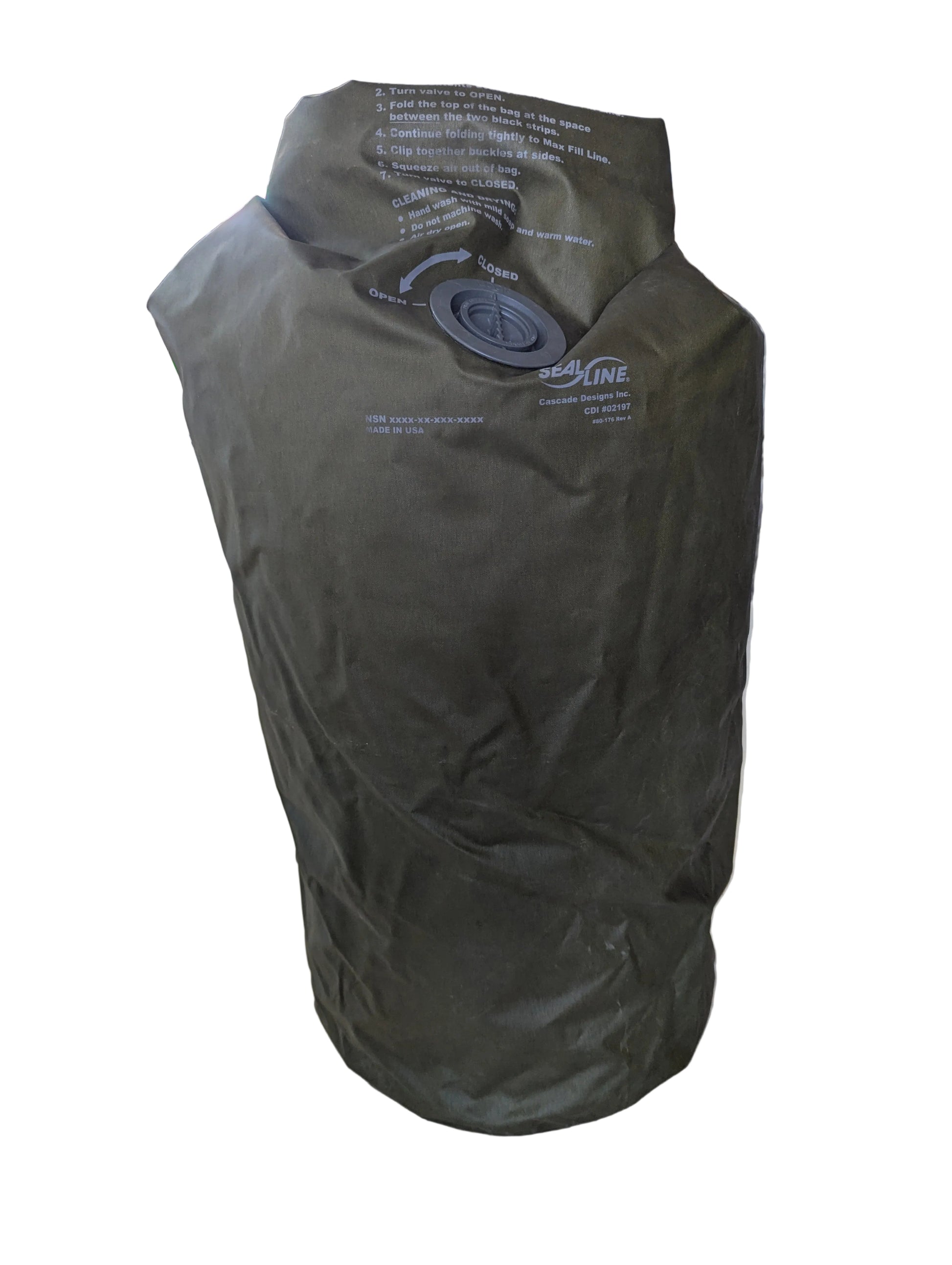 Green dry bag with a valve on a wooden surface