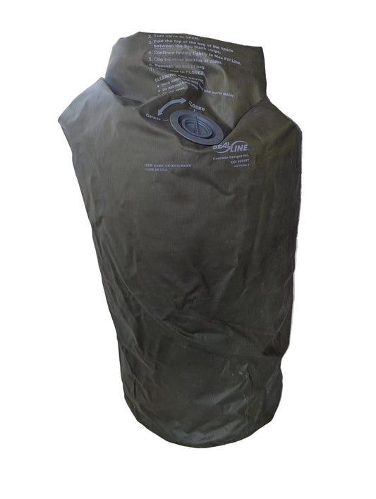 Green dry bag with a valve on a wooden surface