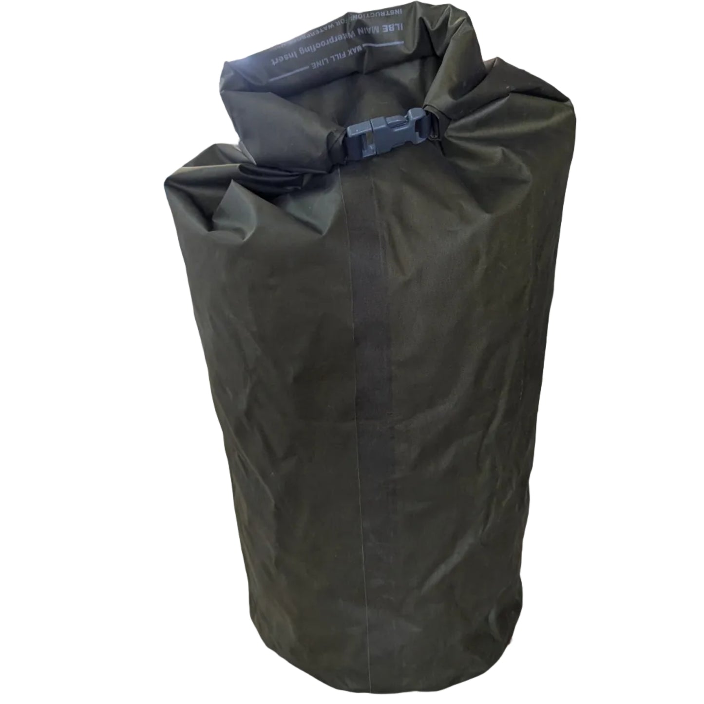 Green dry bag on a table under a tent with boxes and equipment in the background
