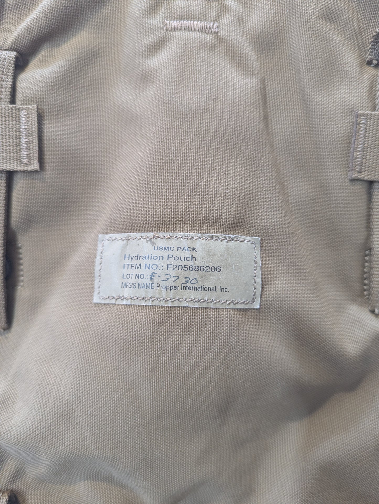 Close-up of a coyote hydration pouch with a label