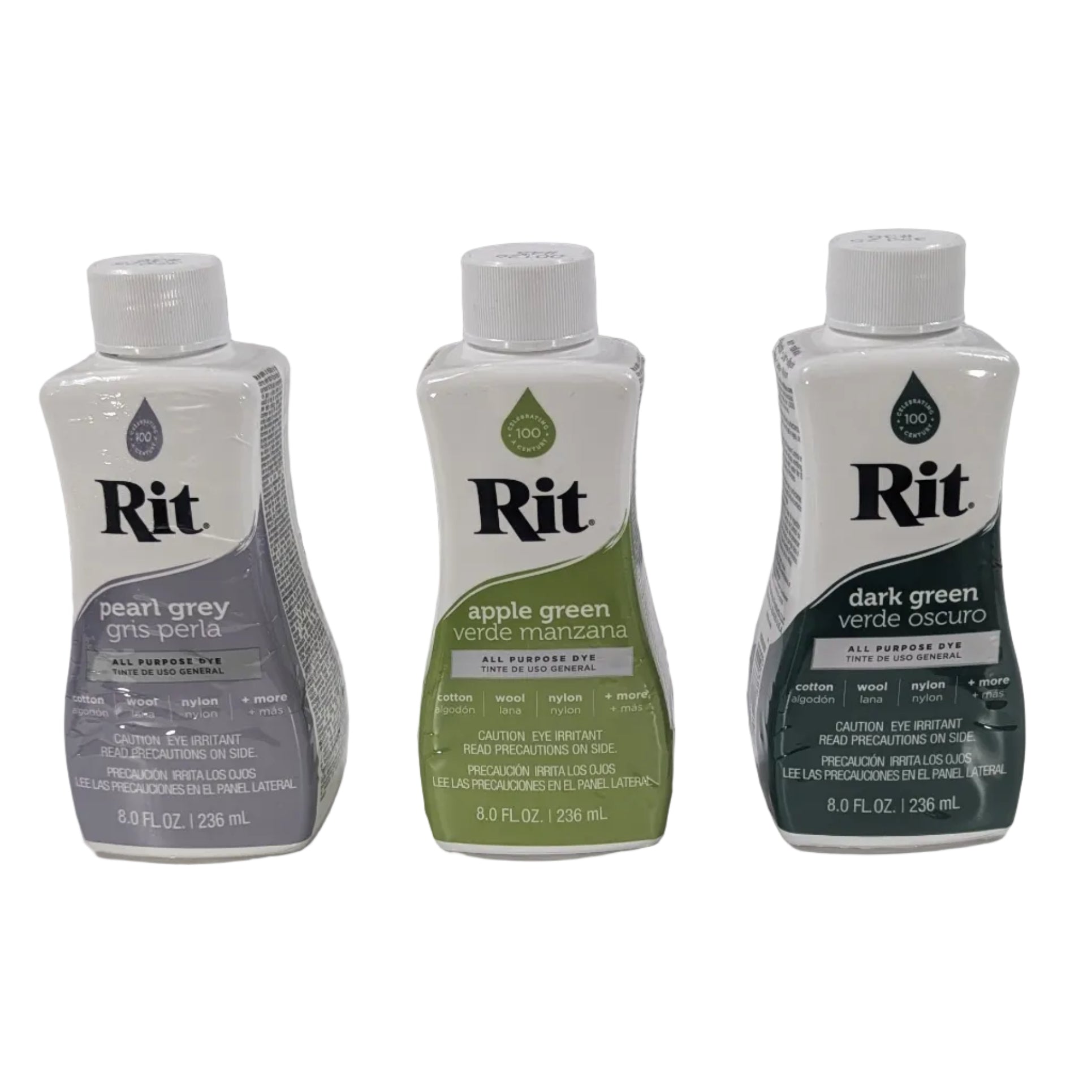 Three bottles of Rit dye on a white surface with a gray background