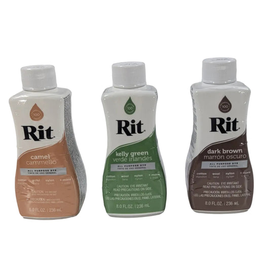 Three bottles of Rit dye on a white surface with a gray background
