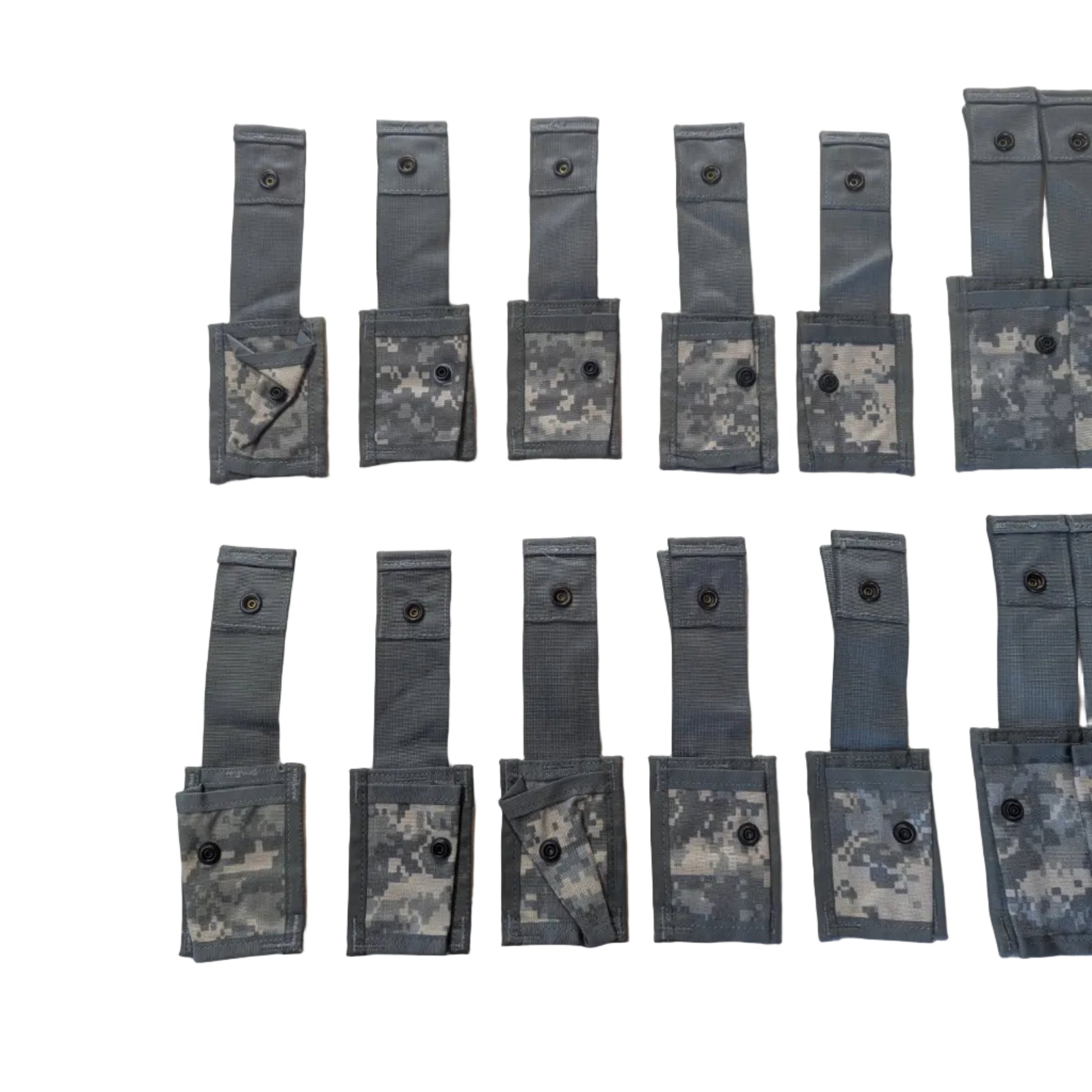 Multiple gray tactical pouches with camouflage patterns arranged on a white surface.