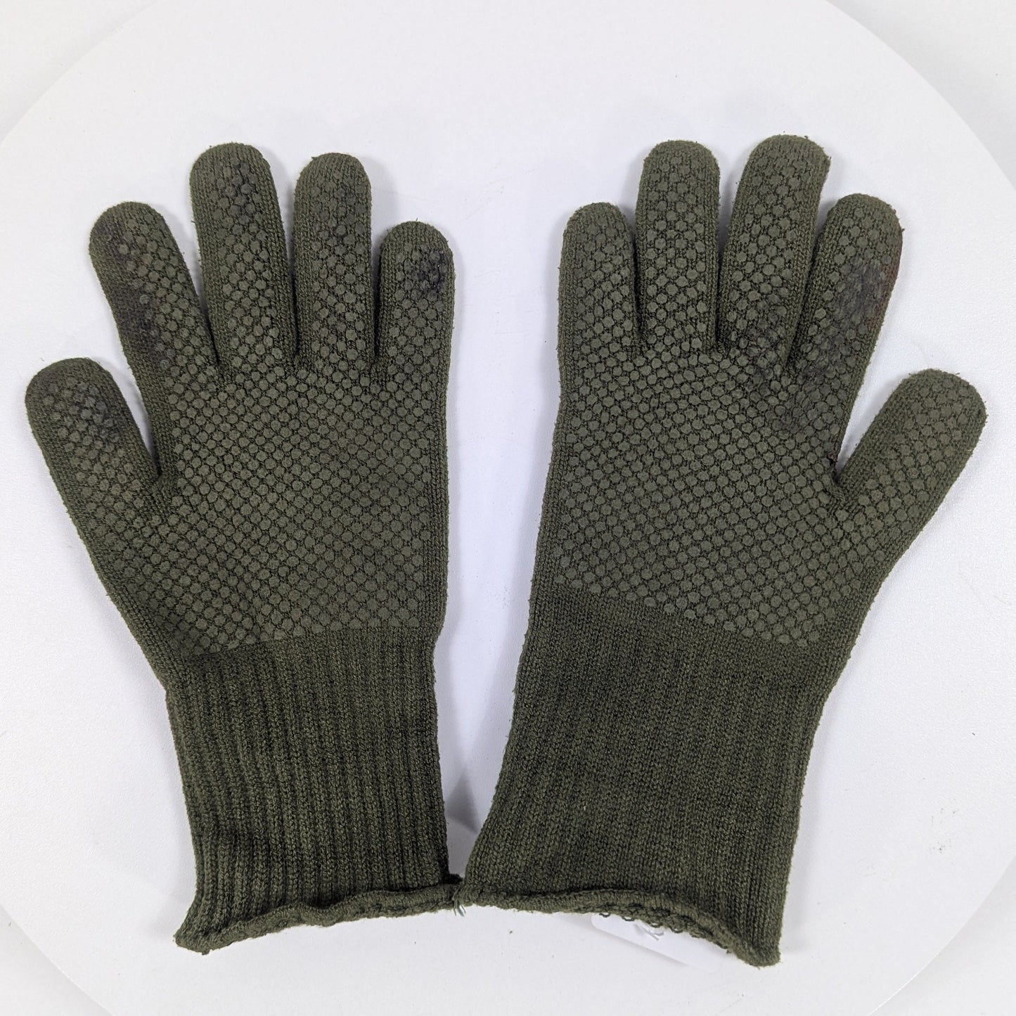 Pair of green gloves with textured palm on a white background