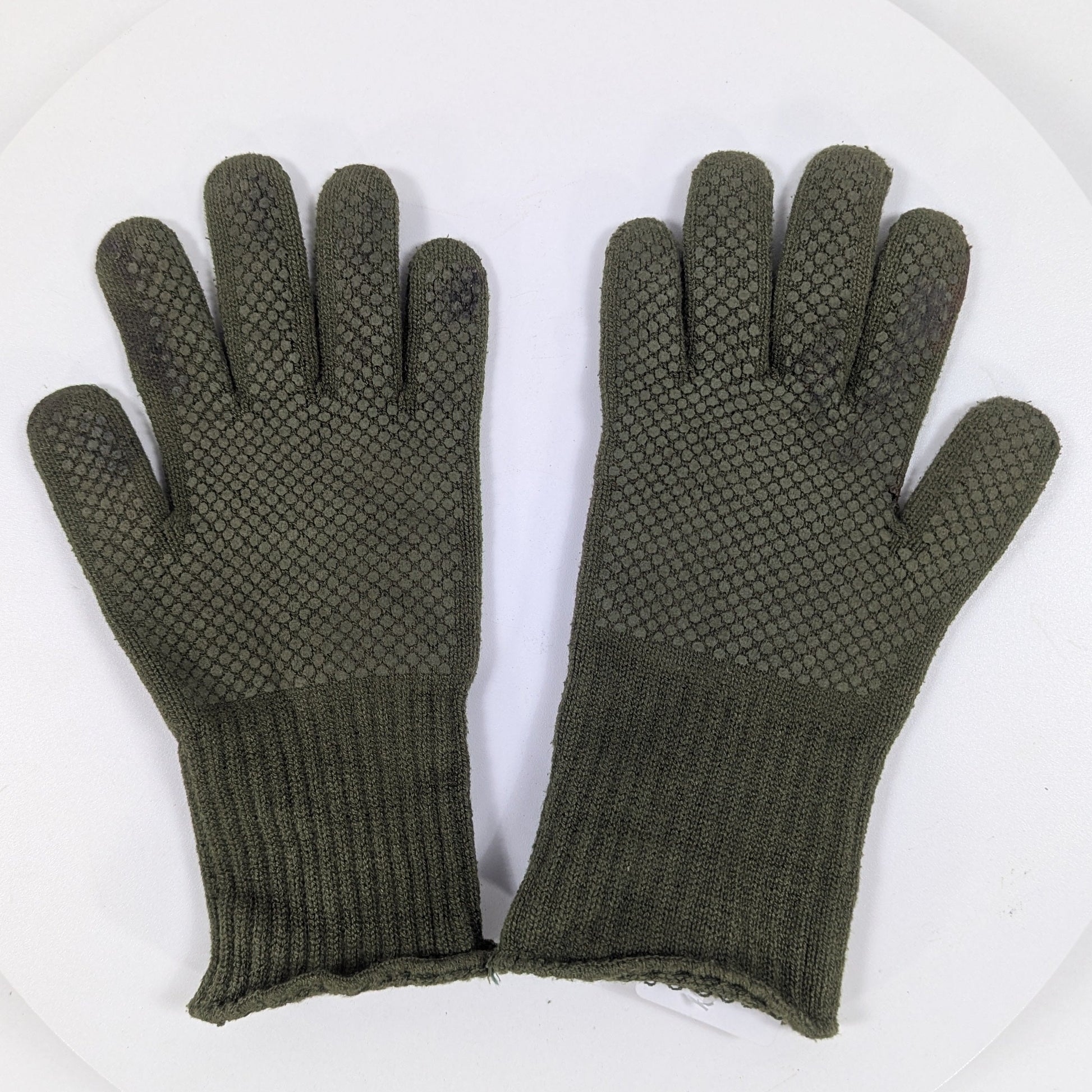 Pair of green gloves with textured palm on a white background