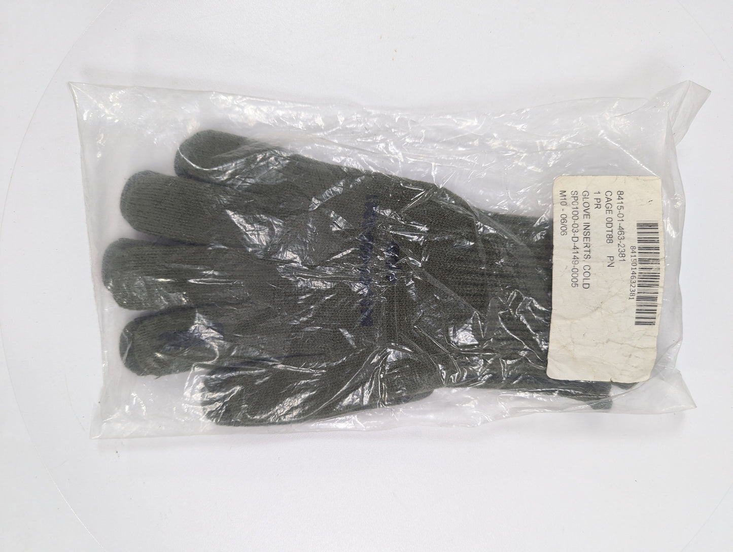Pair of black gloves in a clear plastic bag with a label on a white background