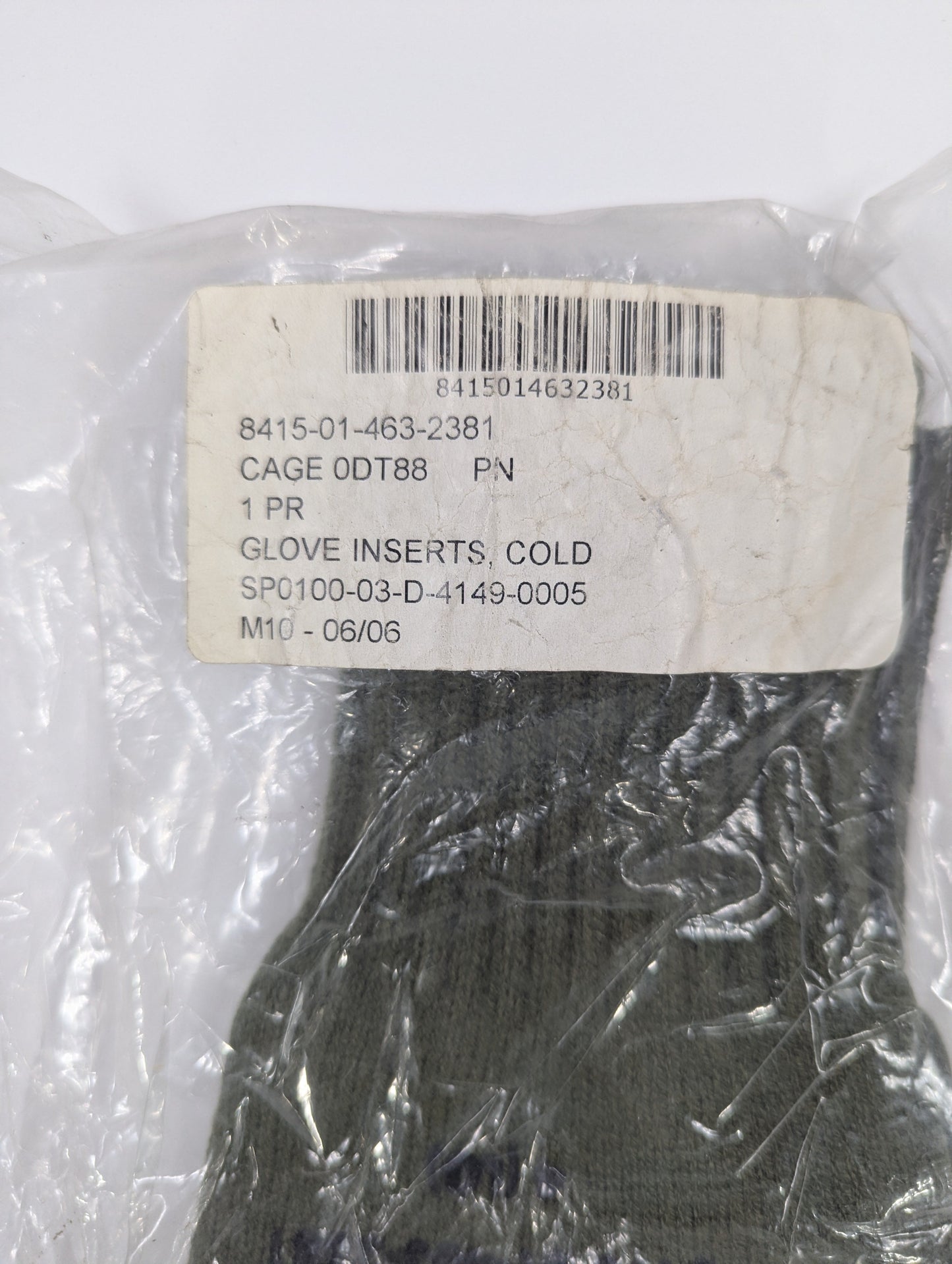 Packaged glove inserts with a label on a white background