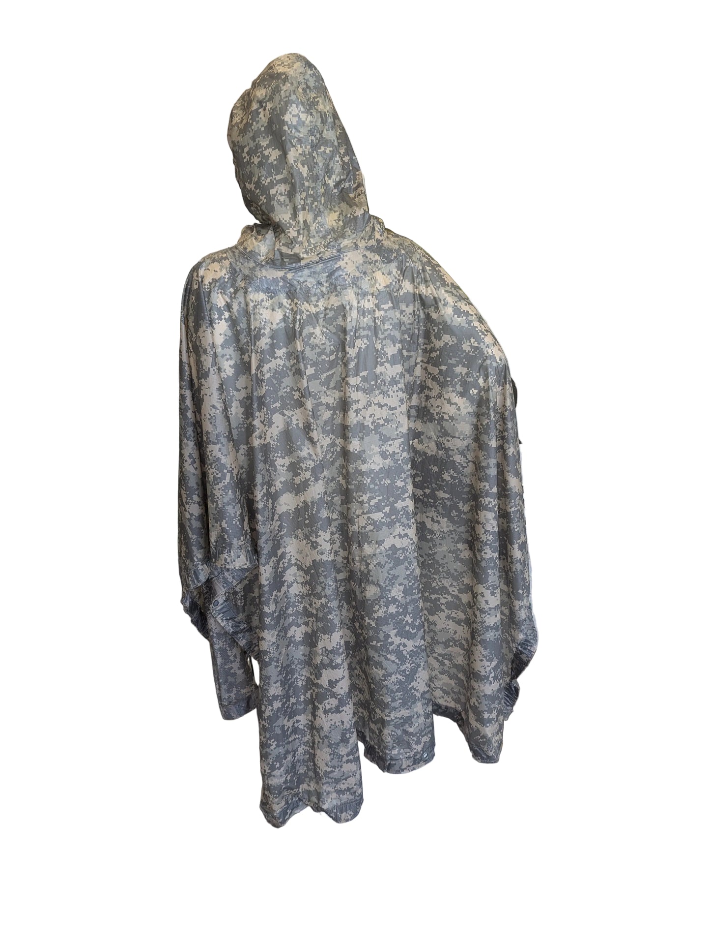 Camouflage hooded poncho on a mannequin in front of a store entrance.