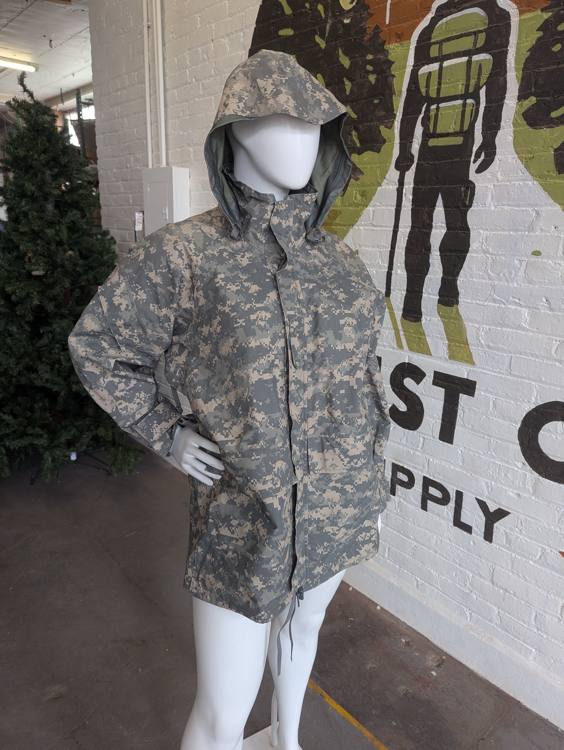 Camouflage jacket on a mannequin in front of a store with 'Last Call Supply' branding.