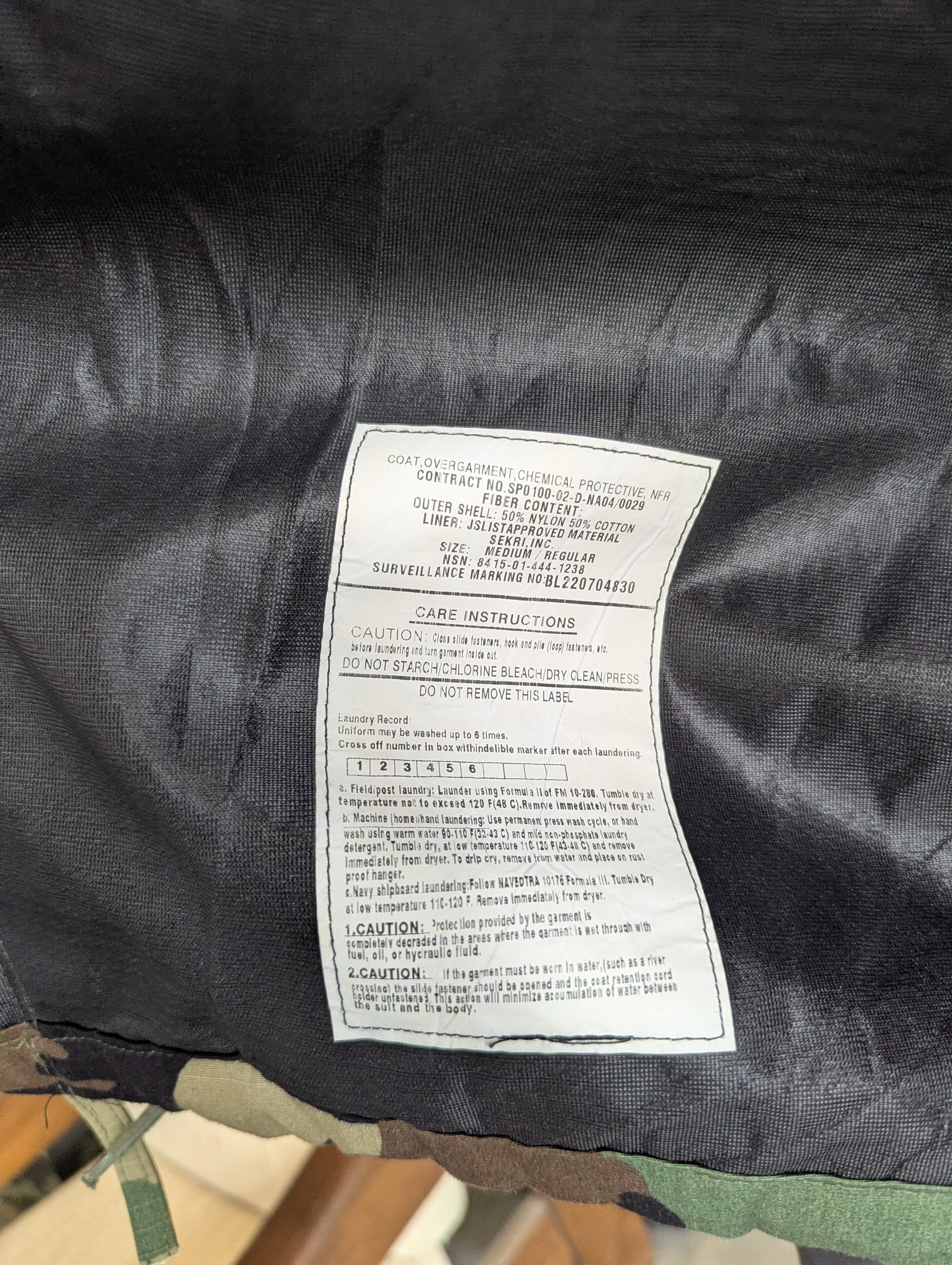 Care label on a black jacket with visible text