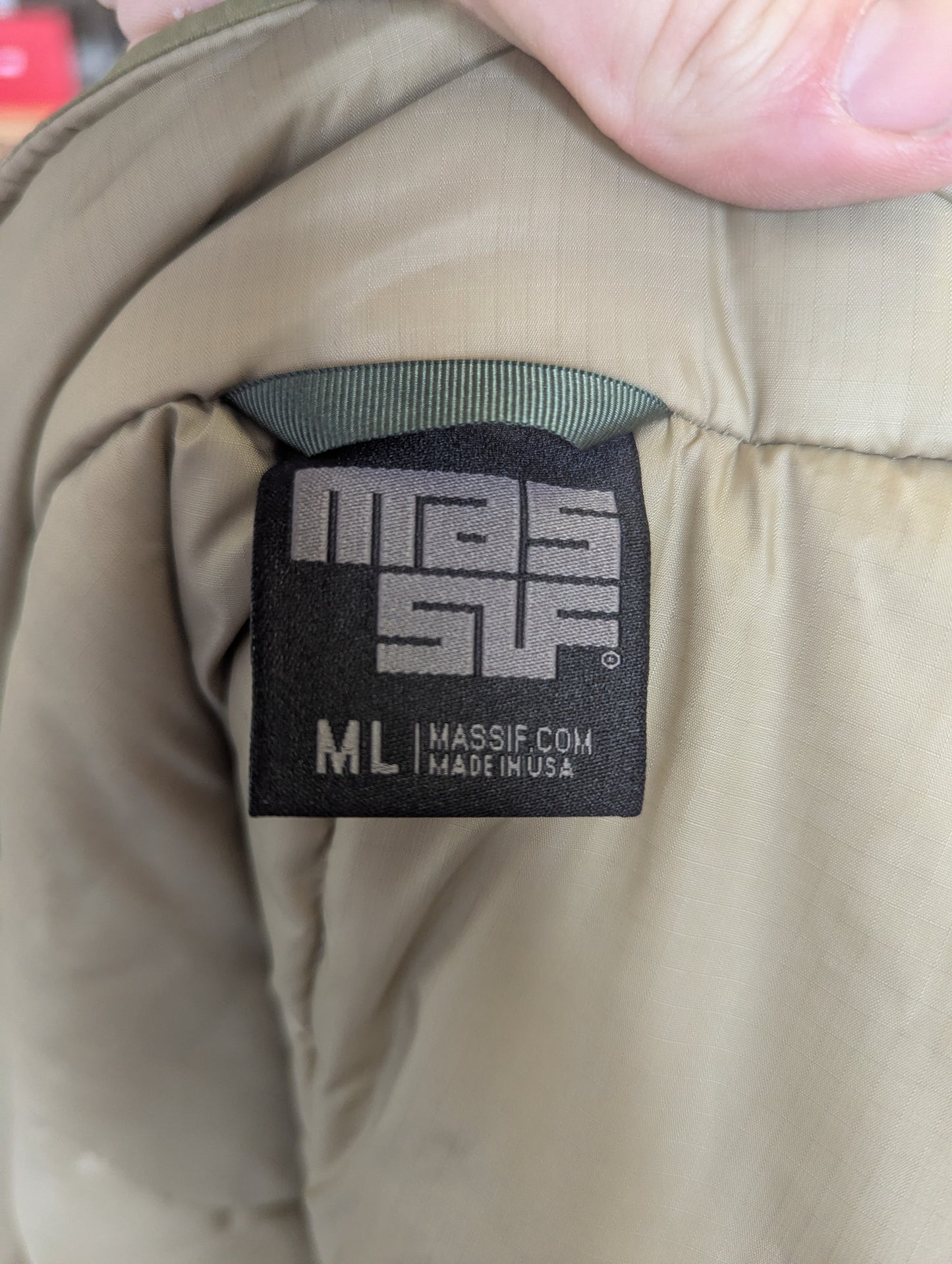Massif clothing label on a beige jacket