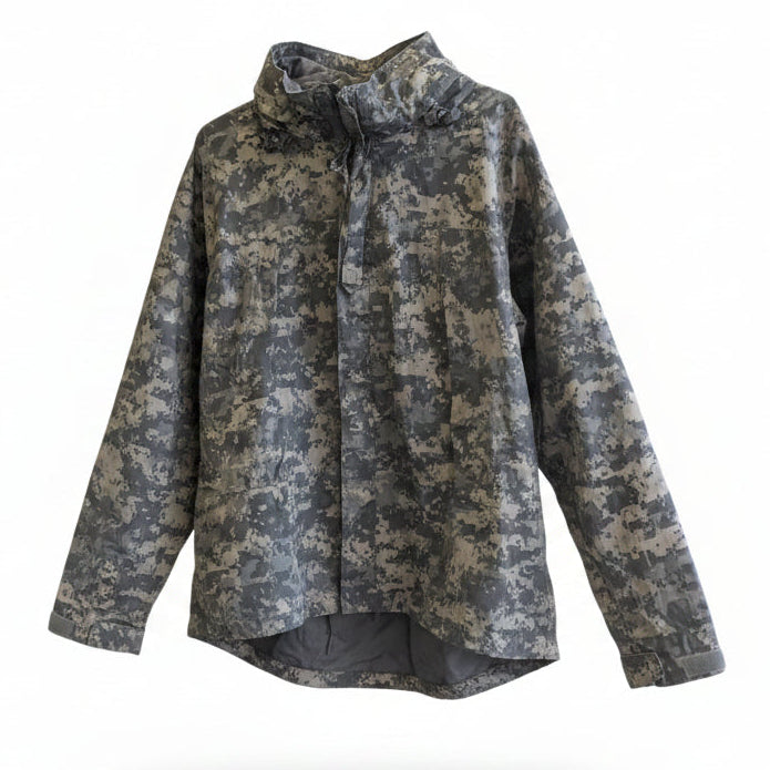 Camouflage jacket on a mannequin in front of a mural with text and abstract designs.