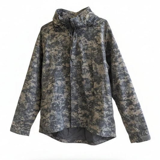 Camouflage jacket on a mannequin in front of a mural with text and abstract designs.