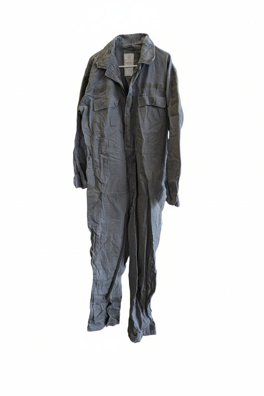 Green jumpsuit on a mannequin against a wall with 'Forest City' branding.