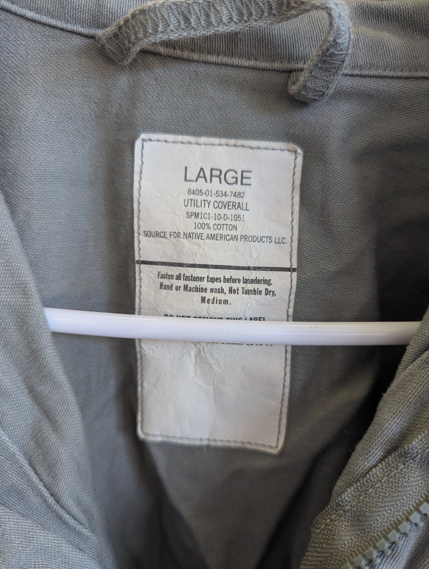Label on a large utility coverall with text and size information.