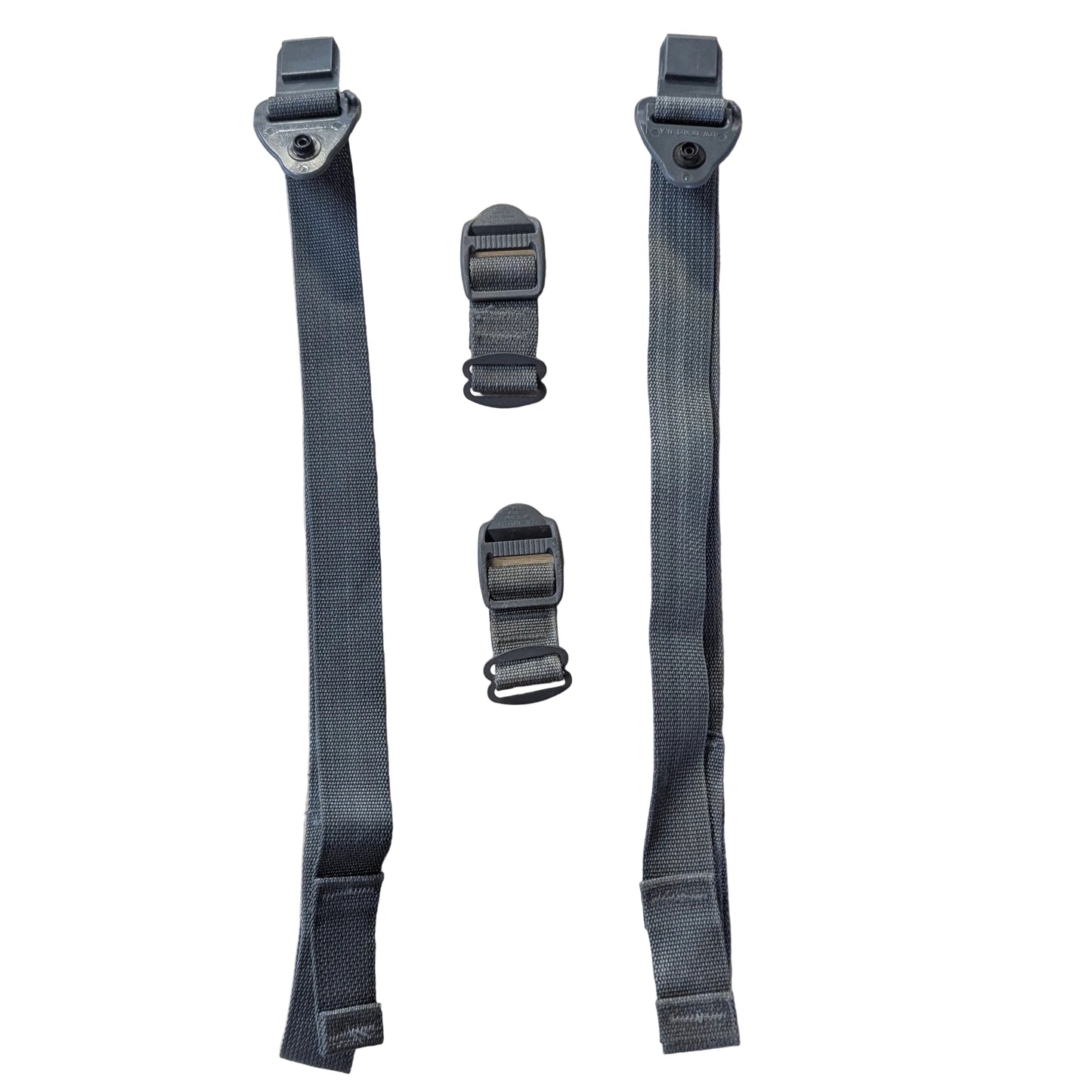 A set of four dark gray nylon webbing straps with metal quick-release buckles, laid out on a light beige textured surface.
