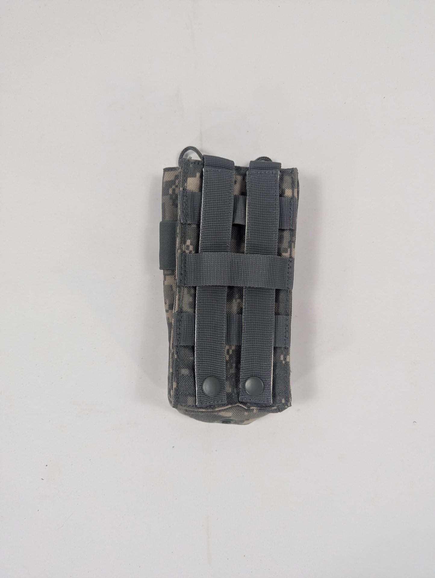 A tactical utility pouch in digital camouflage with dark gray webbing straps, shown against a plain off-white background.