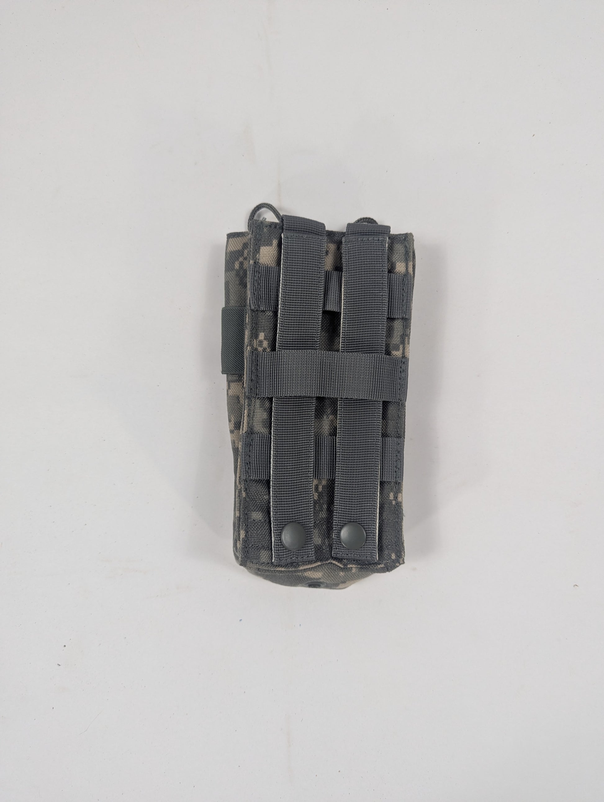 A tactical utility pouch in digital camouflage with dark gray webbing straps, shown against a plain off-white background.