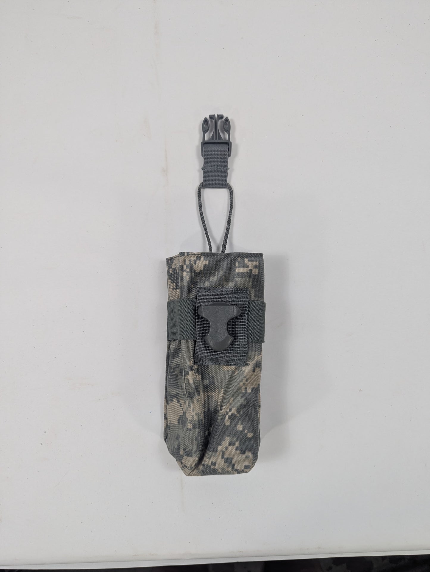 A digital camouflage utility pouch with a dark gray plastic clip and strap, shown against a plain off-white background.