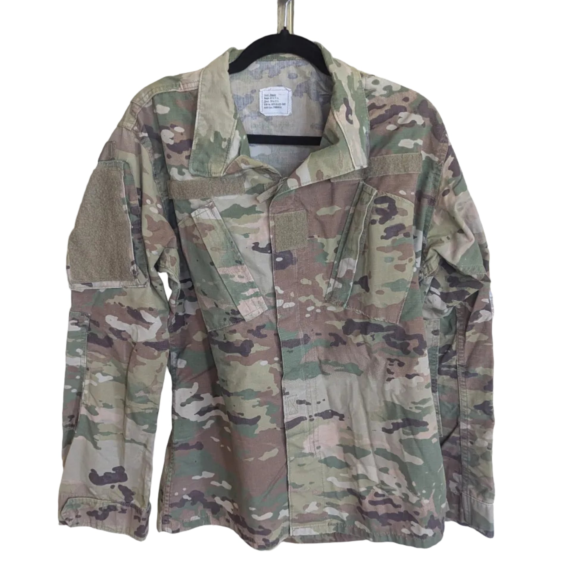 A long-sleeve military-style camouflage jacket hanging on a black hanger from a wooden display stand, set against a white background