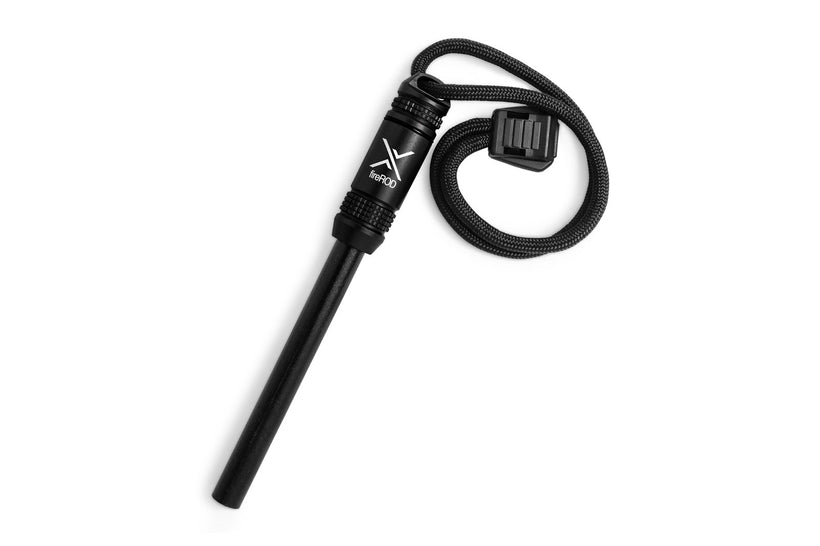 A black fireROD fire starter lying diagonally on a white background, featuring a black anodized aluminum handle, a black ferrocerium rod, and a black paracord lanyard.