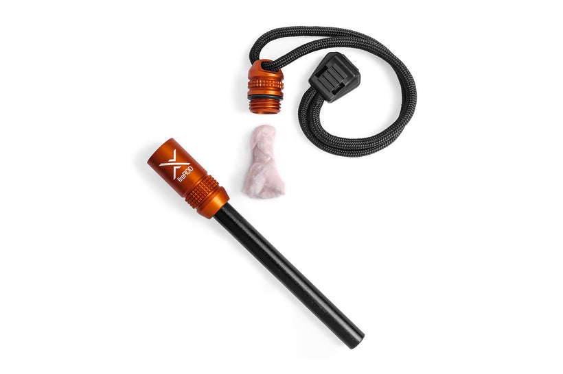 The orange fireROD fire starter disassembled on a white background, showing the anodized aluminum handle, the black ferrocerium rod, the striker, and the piece of included emergency tinder.