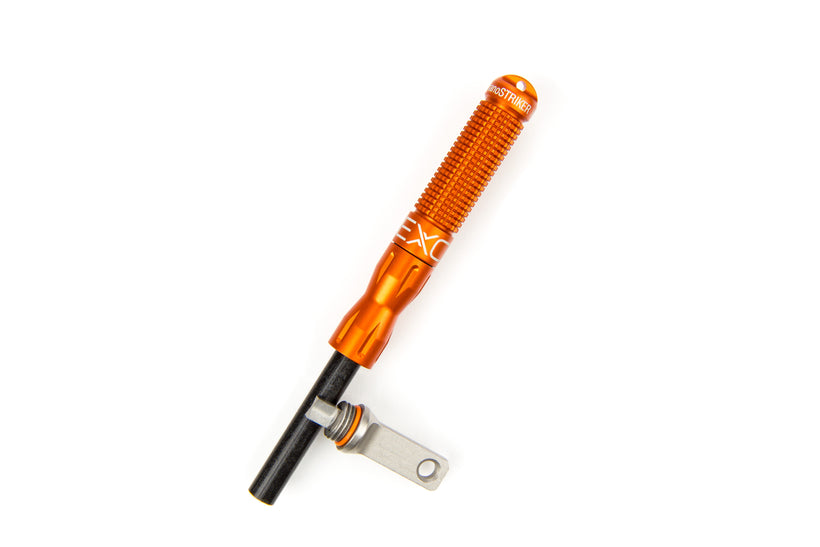 A single blaze orange nanoSTRIKER XL fire starter lying diagonally on a white background, displaying its textured body and the exposed black ferrocerium rod with the silver striker.