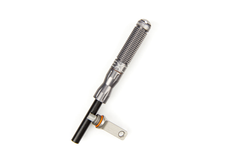 A single gunmetal nanoSTRIKER XL fire starter standing upright on a white background, displaying its textured body and the exposed black ferrocerium rod with the silver striker.