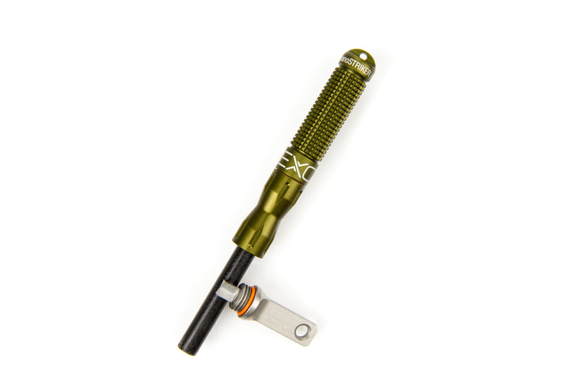 A single olive green nanoSTRIKER XL fire starter standing upright on a white background, displaying its textured body and the exposed black ferrocerium rod with the metal striker.