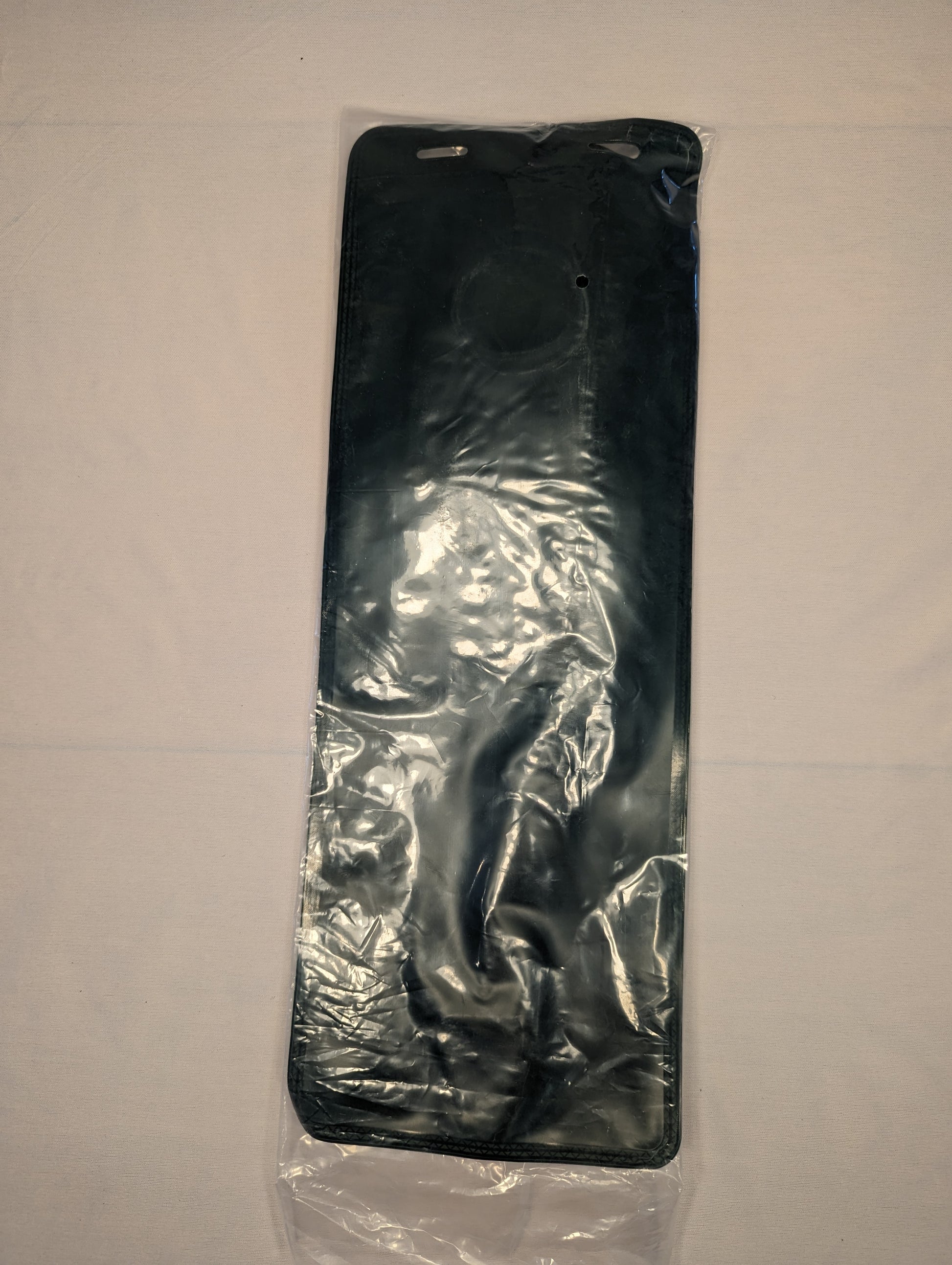 A brand new, black 3-Liter hydration reservoir, sealed in clear plastic packaging, displaying the flexible body and circular filler port area.