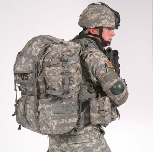 A U.S. Army soldier in full ACU digital camouflage uniform and helmet, viewed from the side, carrying a fully loaded MOLLE II Large Rucksack with attached pouches and visible 'US' markings.