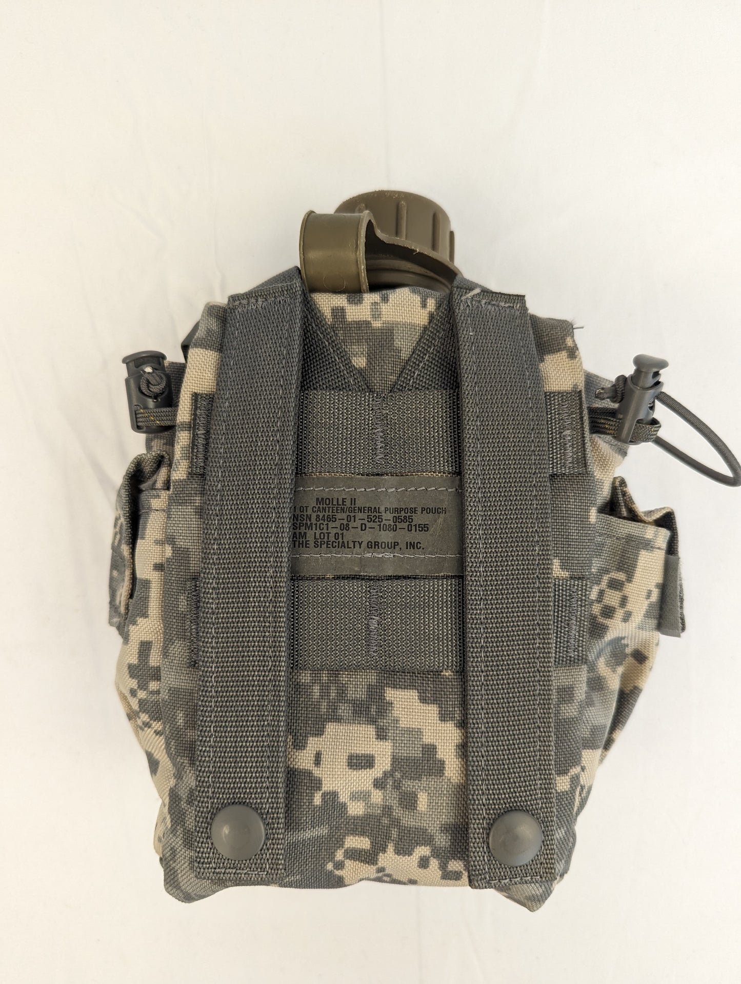 A single U.S. Military Surplus ACU camouflage pouch for a 1-quart canteen, photographed from the back, clearly displaying the MOLLE webbing attachment straps and ID tag on a white background.